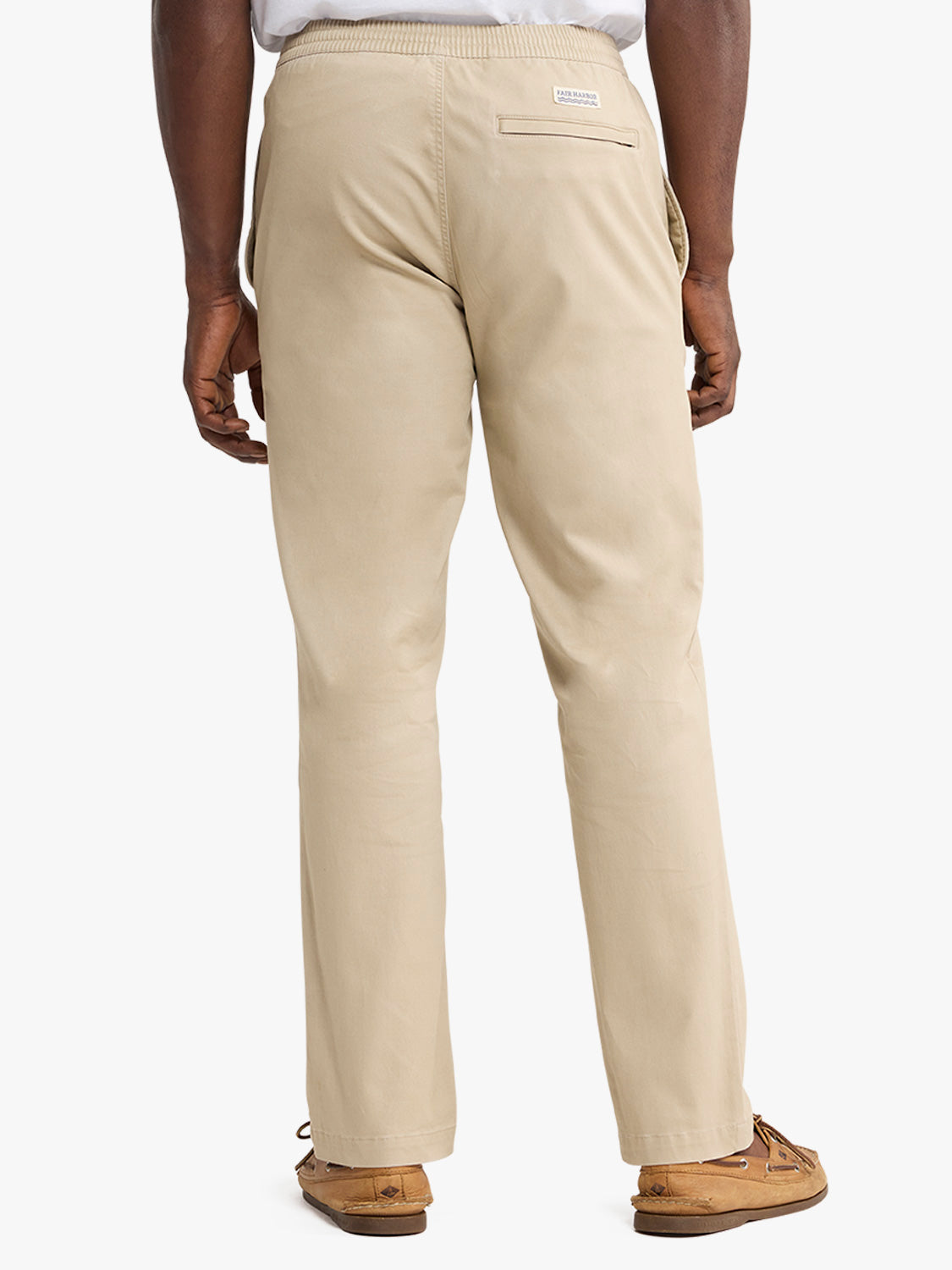 Man wearing khaki pull-on pants with elastic waistband and back pocket viewed from behind.