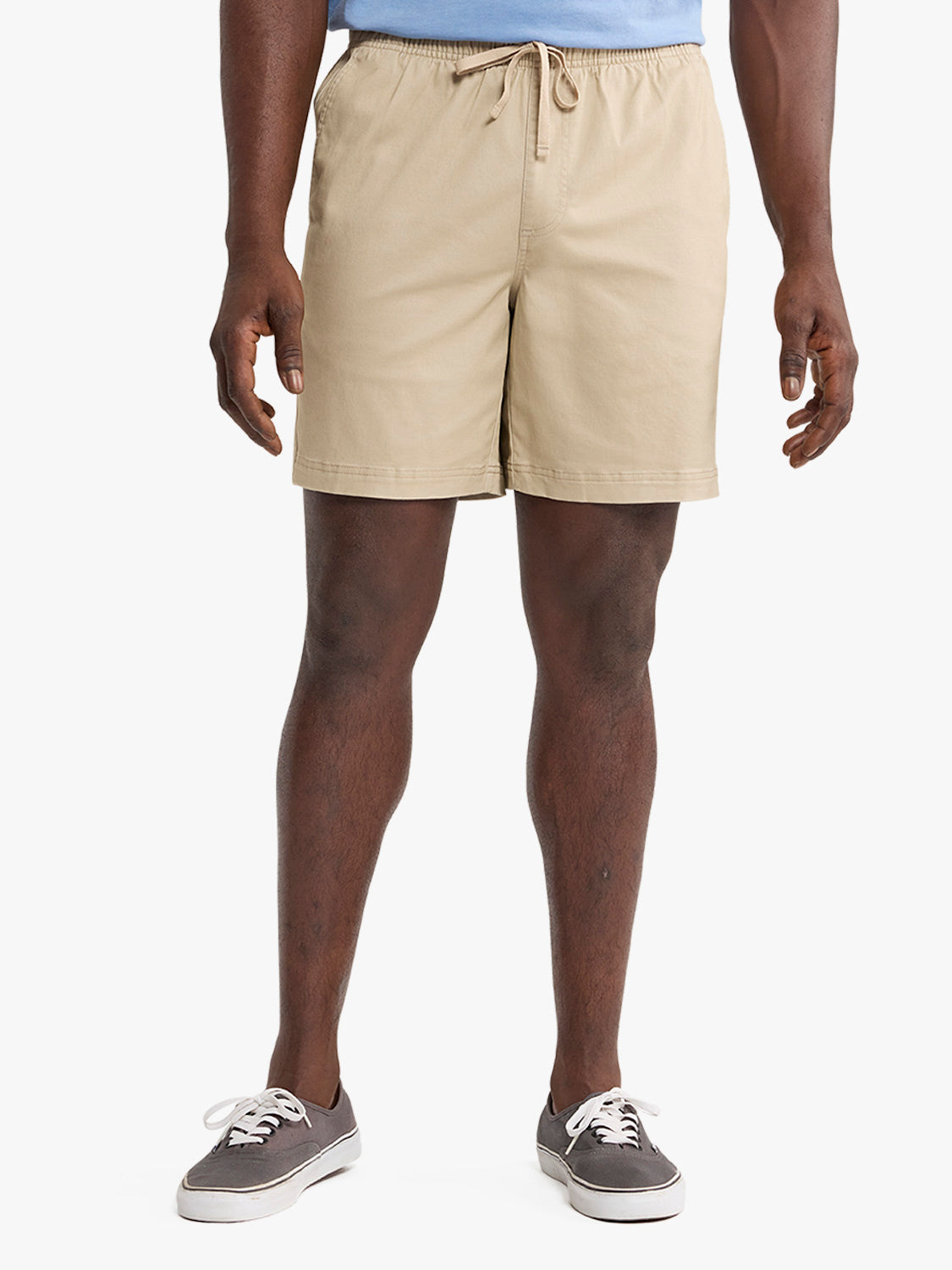 Man wearing khaki pull-on shorts with a drawstring waist and blue shirt above.
