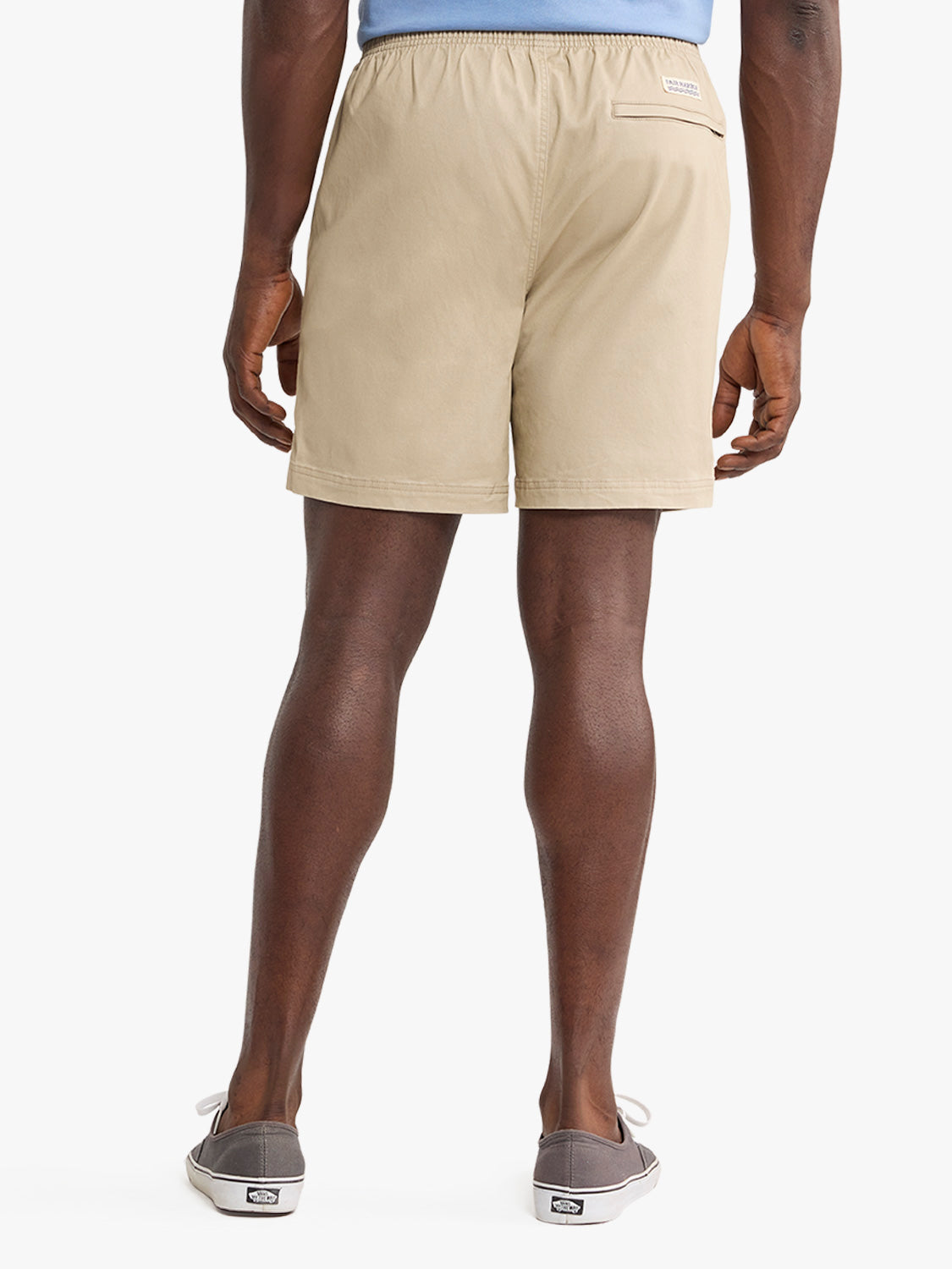 Man wearing khaki pull-on shorts with elastic waistband and back pocket viewed from behind.
