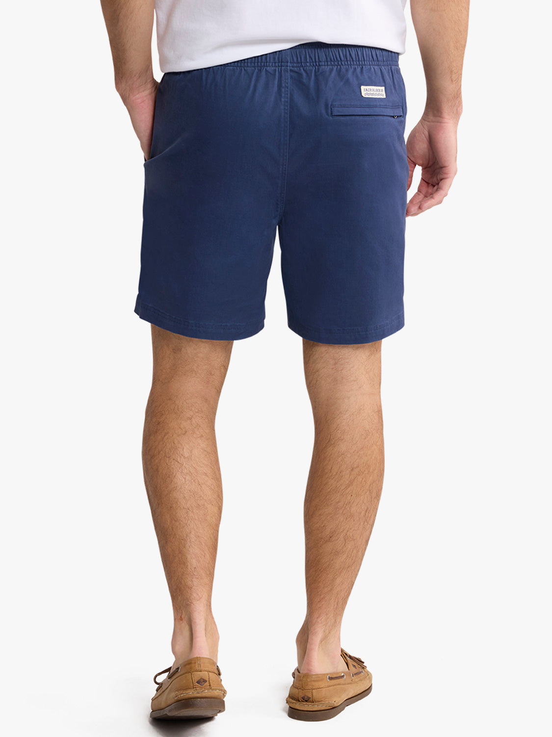 Man wearing navy pull-on shorts with an elastic waistband and rear pocket, paired with a white shirt.