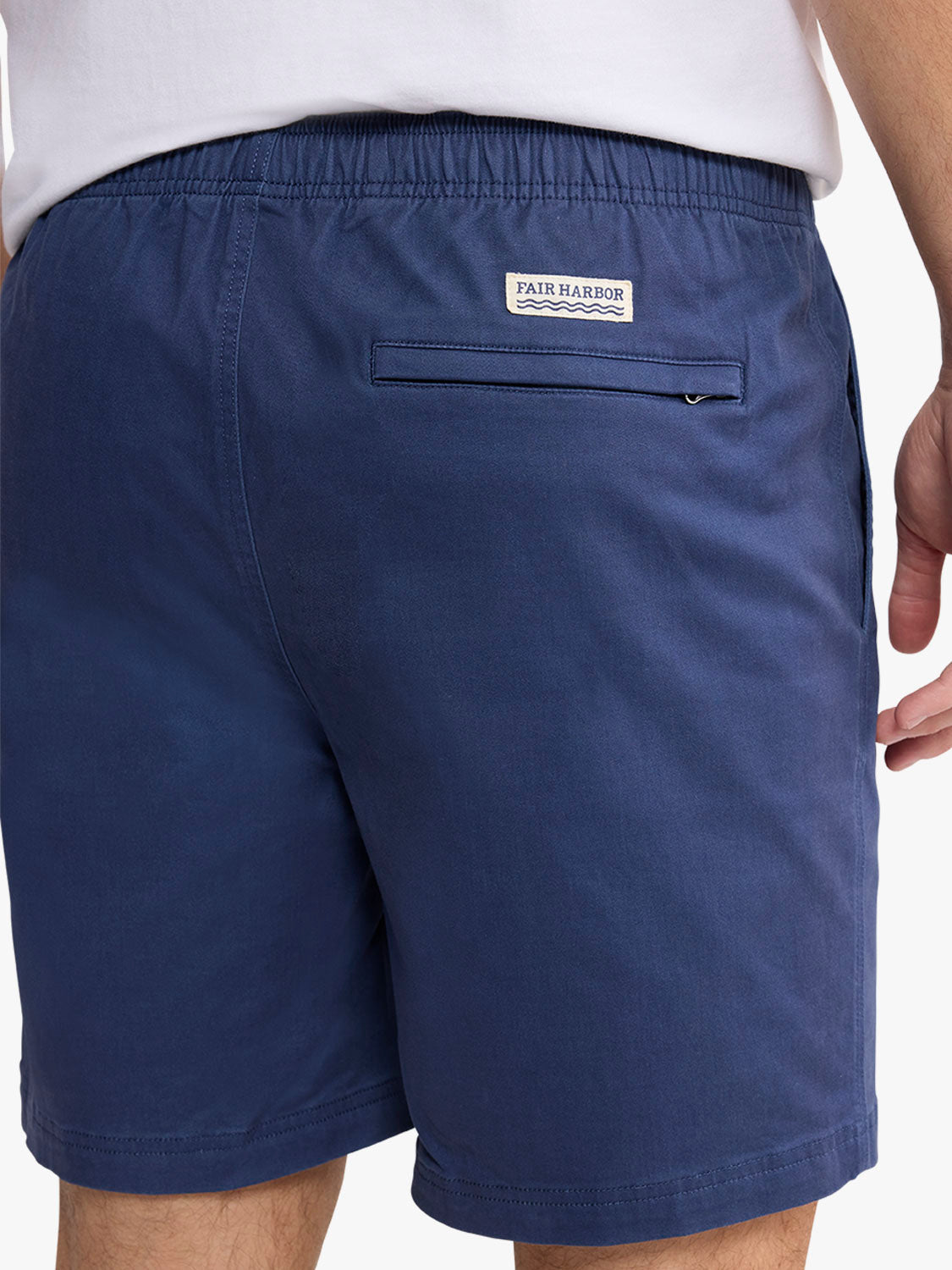 Navy pull-on shorts with elasticized waistband, back pocket, and Fair Harbor brand label visible.