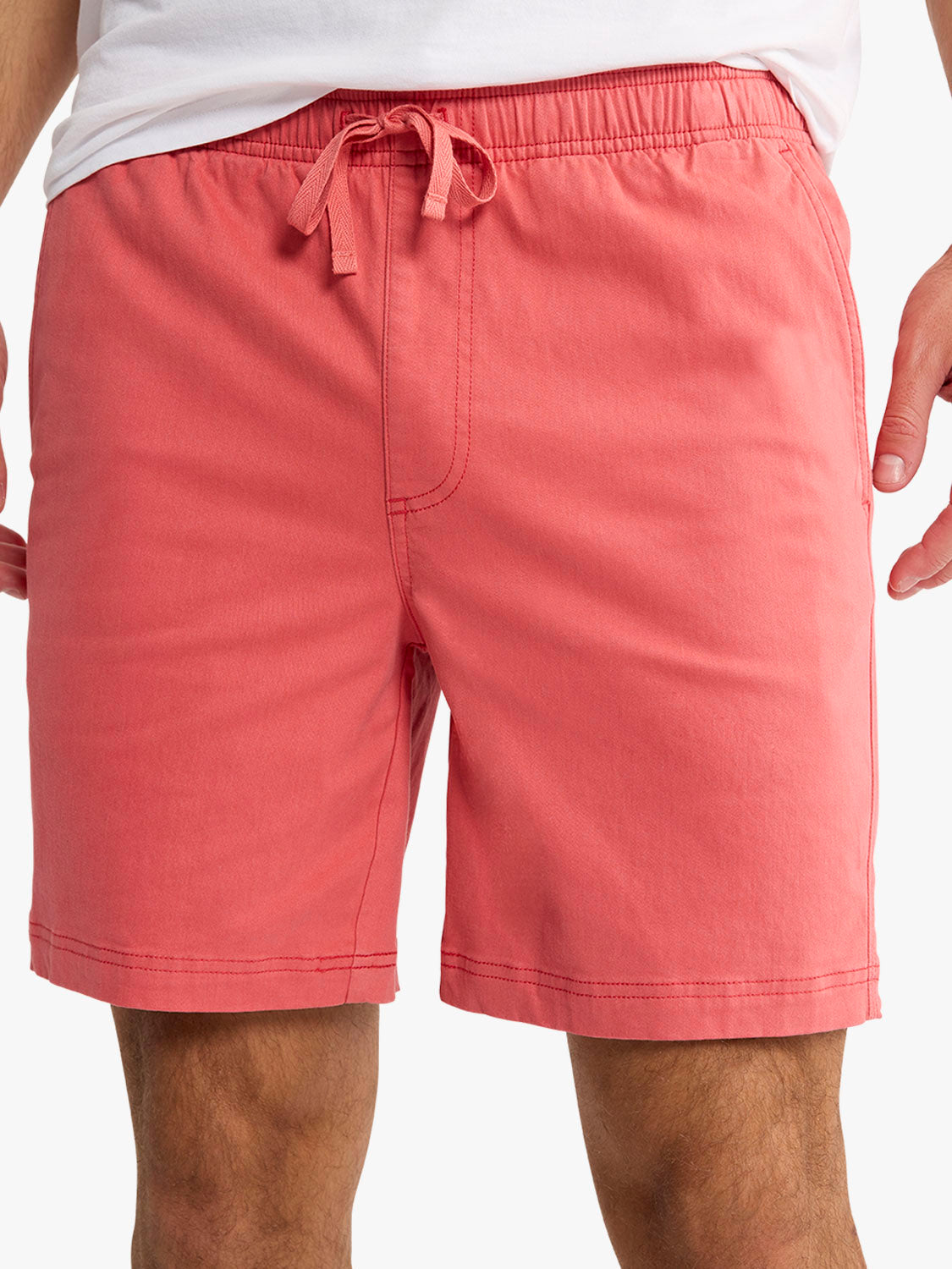 Washed red pull-on shorts with an elastic waistband and drawstring tie displayed on a model.