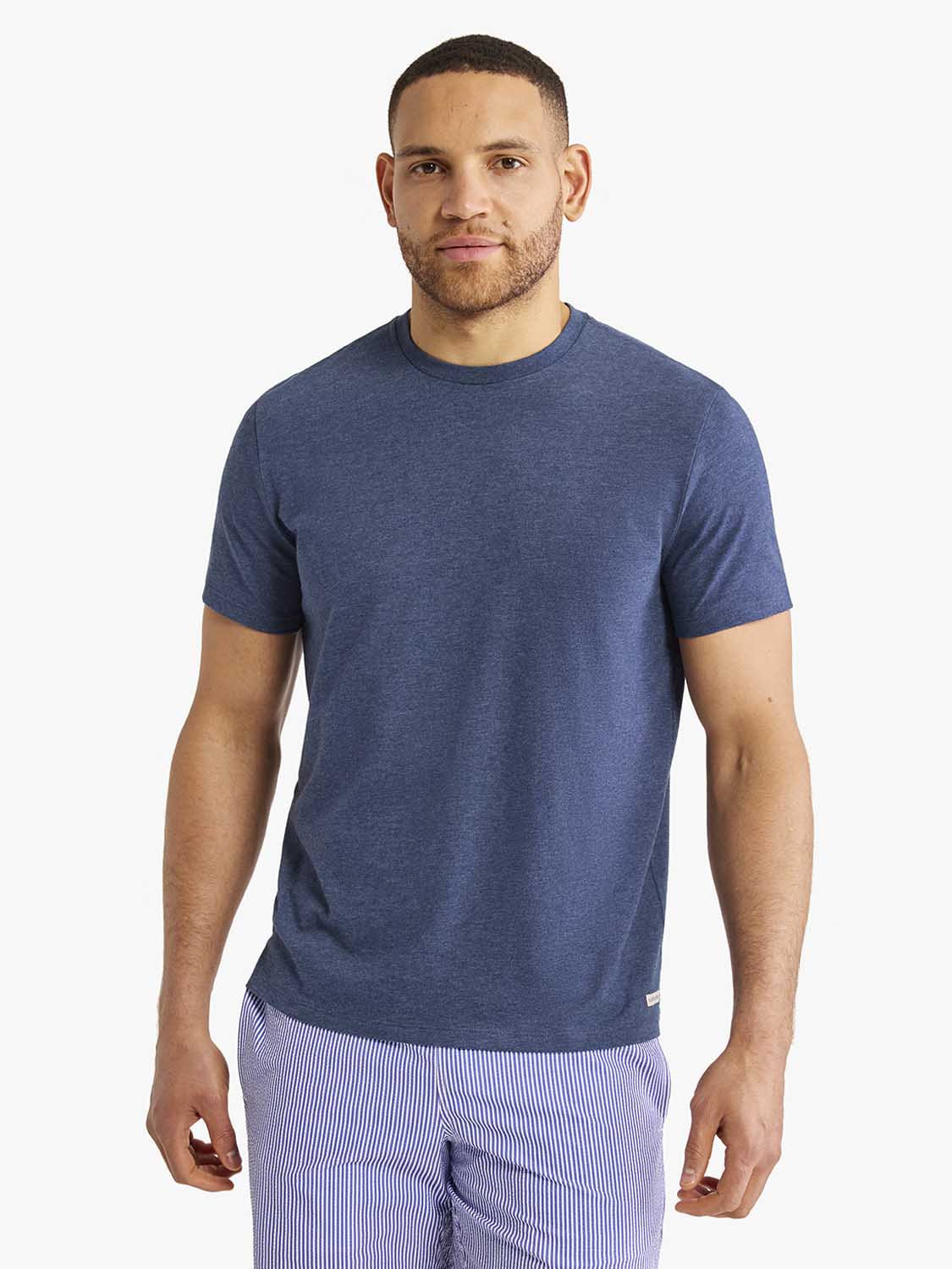 Man wearing a navy blue short-sleeve crew neck t-shirt with a relaxed fit.