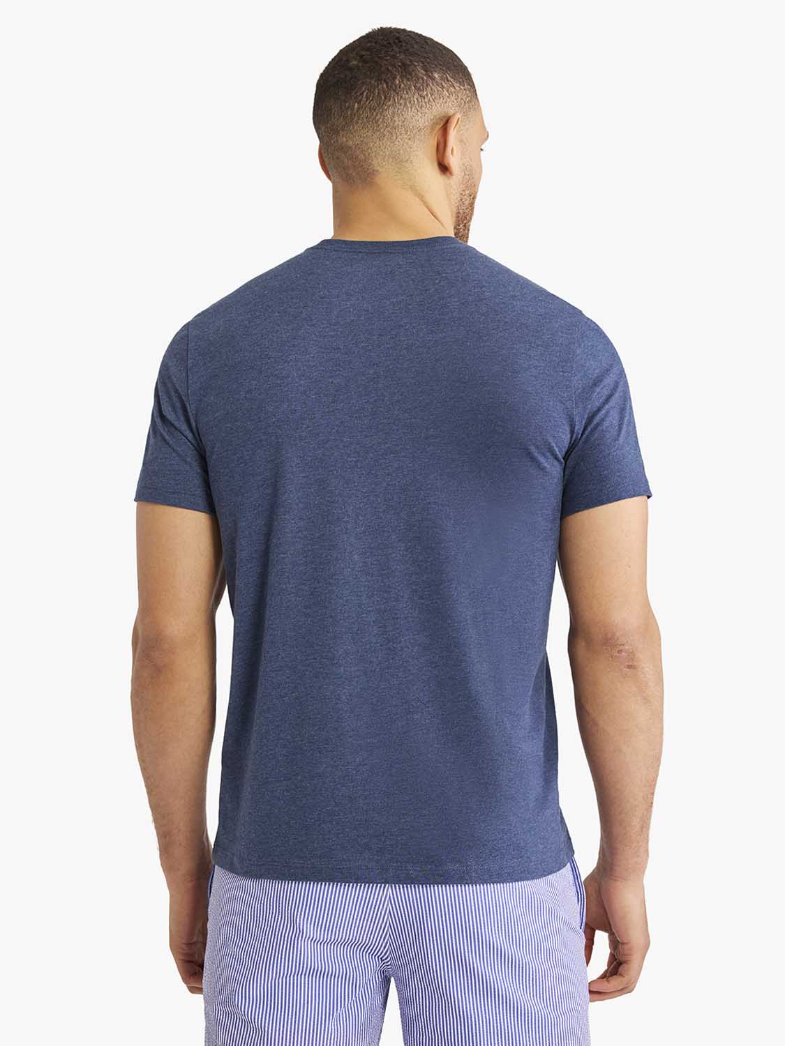 Man wearing a navy blue short-sleeved t-shirt, shown from the back view.