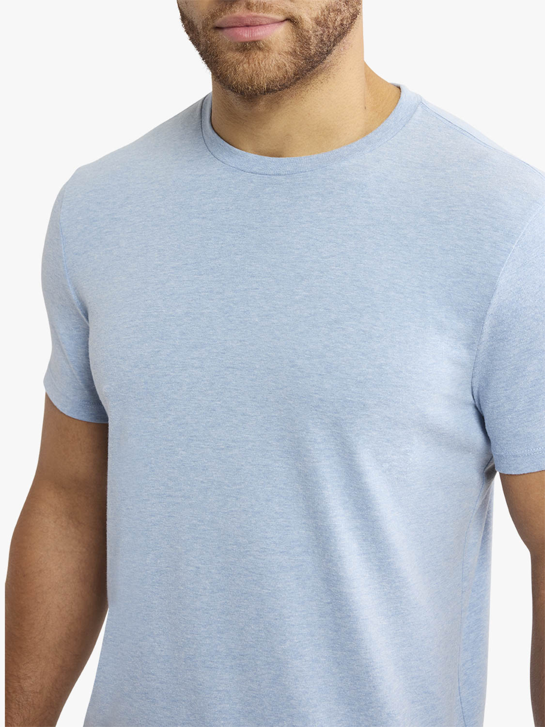 Man wearing a light blue faded denim crewneck short-sleeve t-shirt.