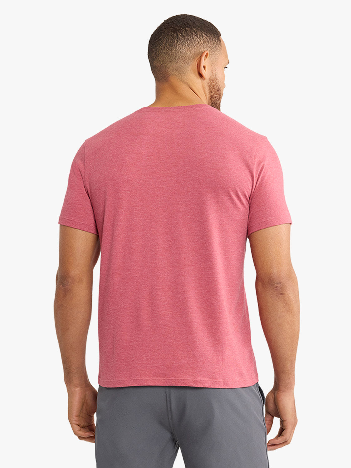 Man wearing a red heathered crew neck t-shirt with short sleeves, shown from the back.