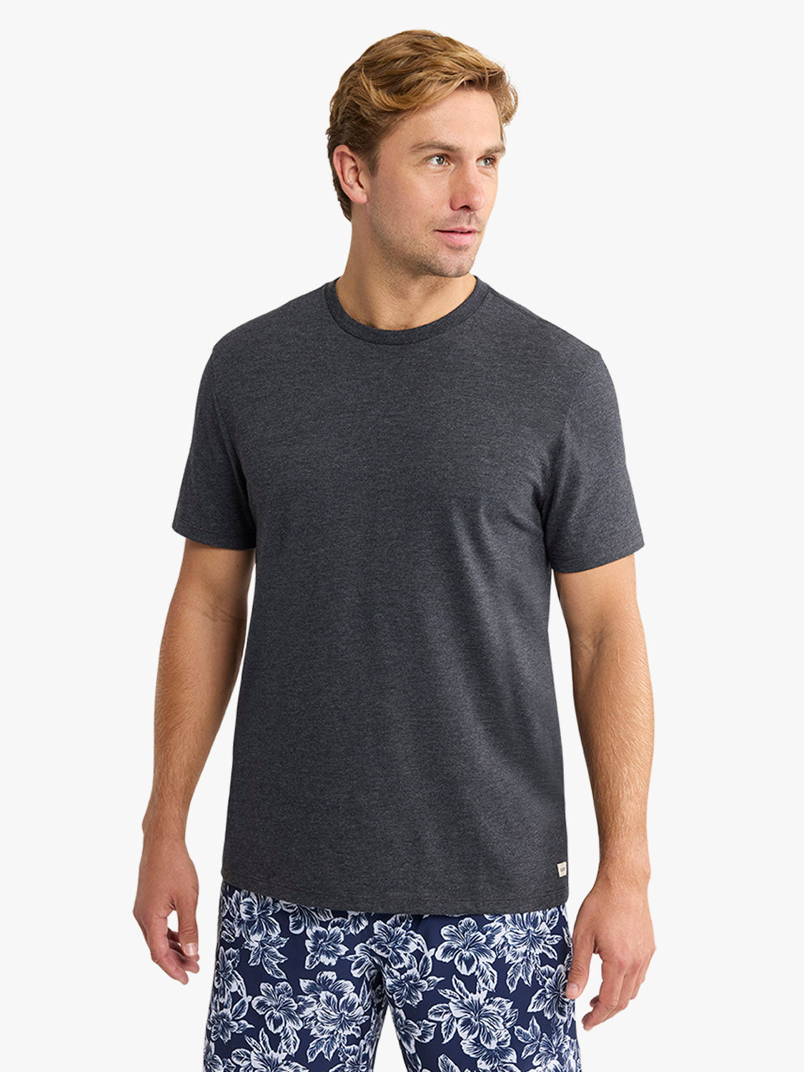 Man wearing a dark gray short-sleeve crewneck t-shirt with a simple solid design.