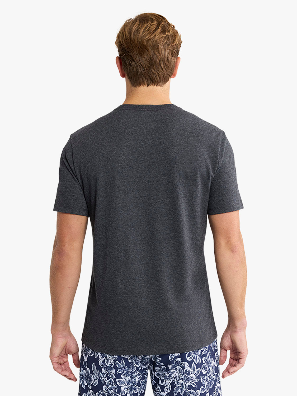 Man wearing a charcoal gray short-sleeved t-shirt, shown from behind against a white background.