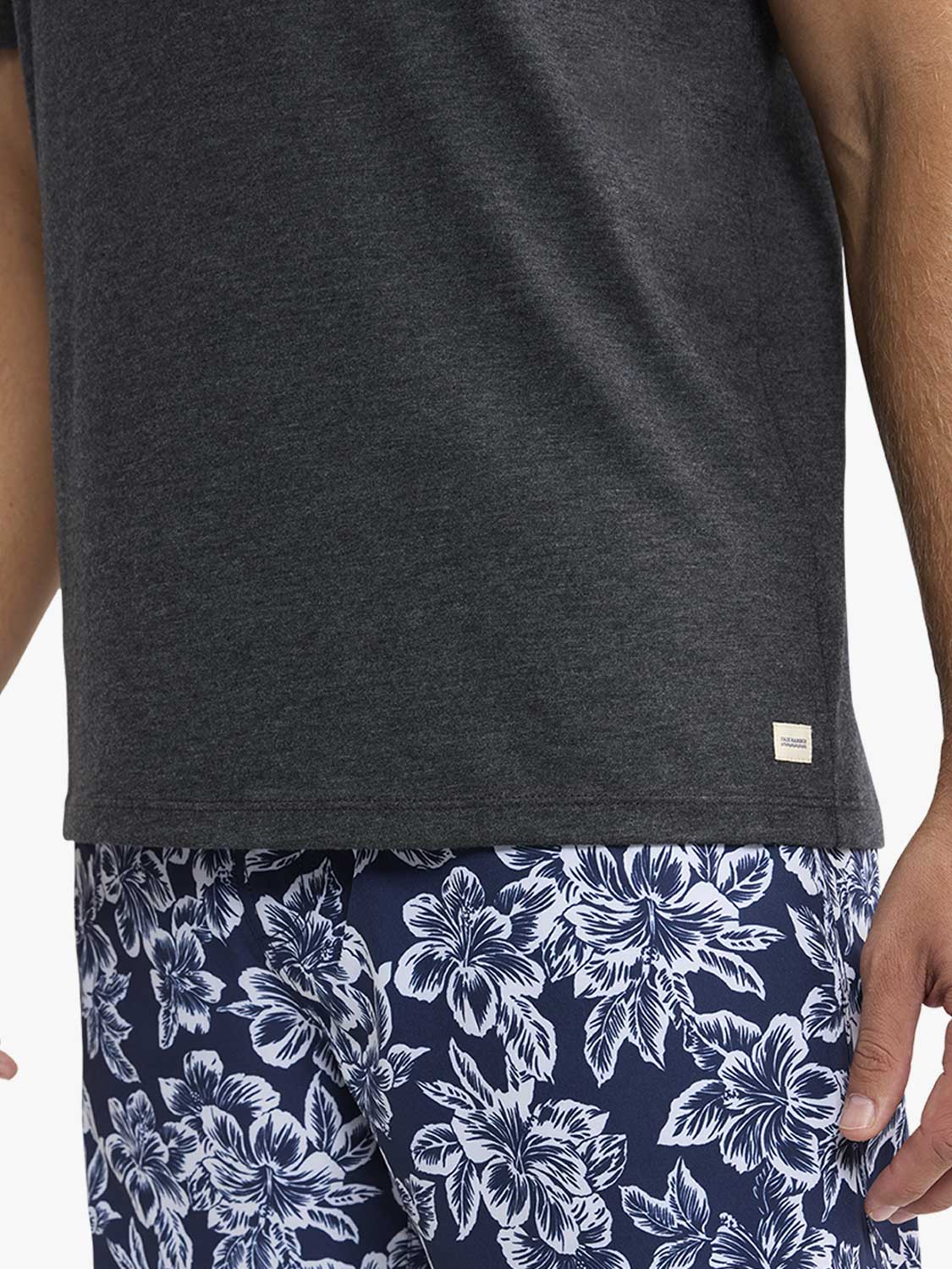 Dark gray heathered t-shirt with small white label patch on front side seam.