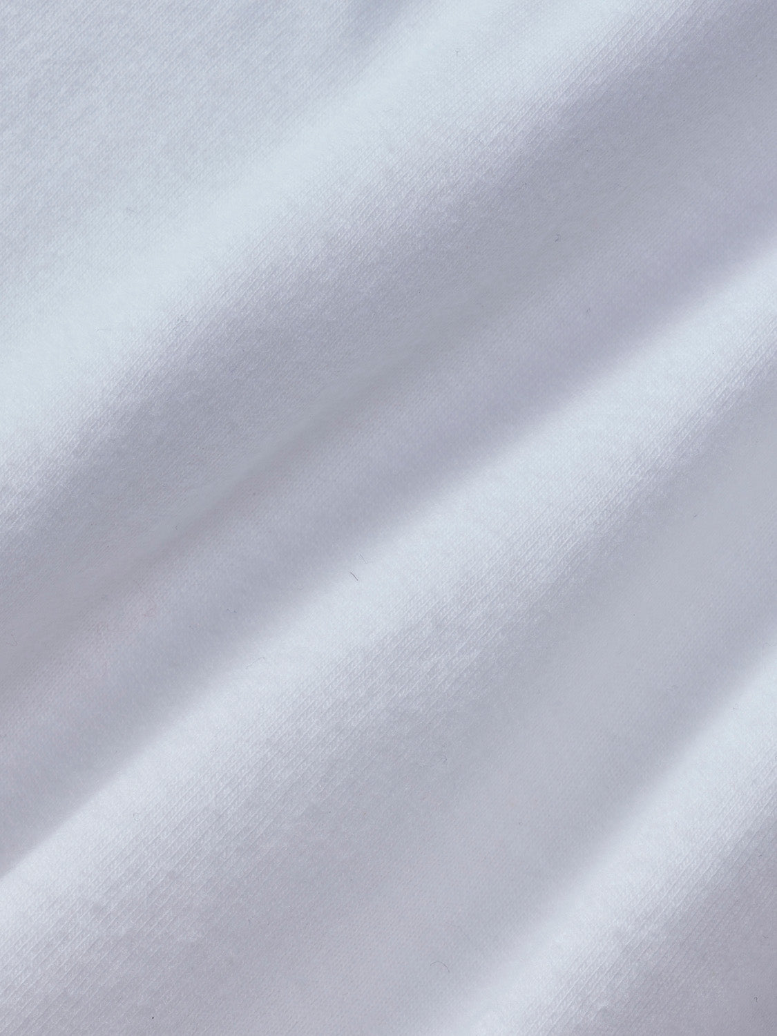 Café-colored graphic tee with textured fabric surface and diagonal shadow details.