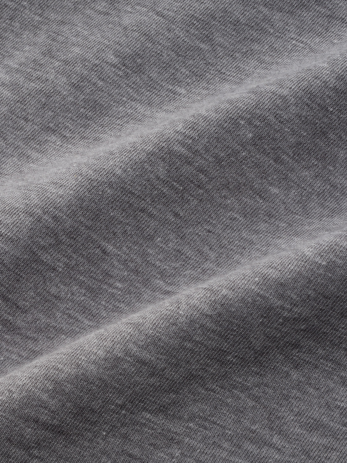 Gray textured fabric with diagonal ribbed weave pattern and subtle shading variations throughout.