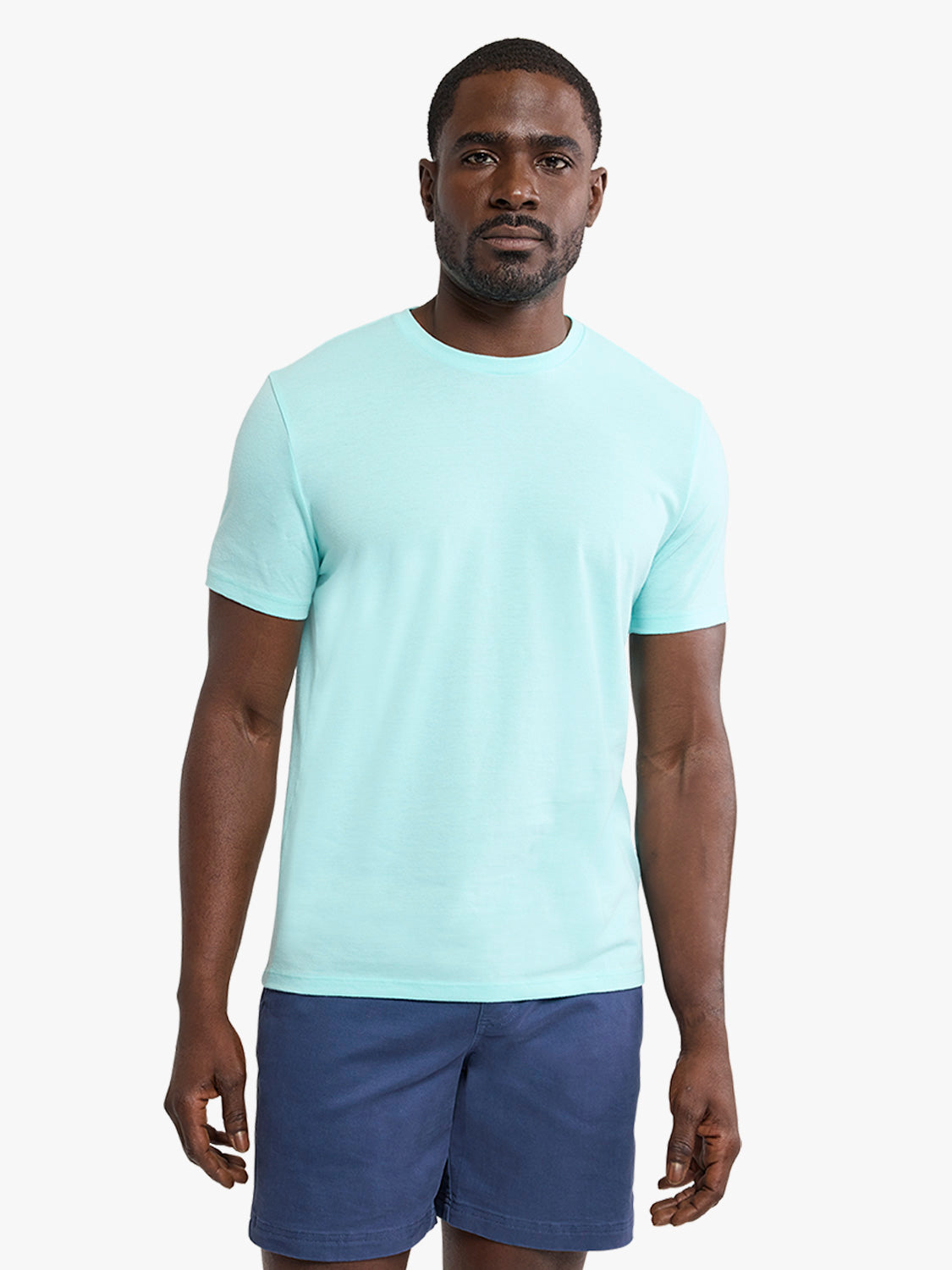 Man wearing an aqua short-sleeve crew neck t-shirt and navy blue shorts.