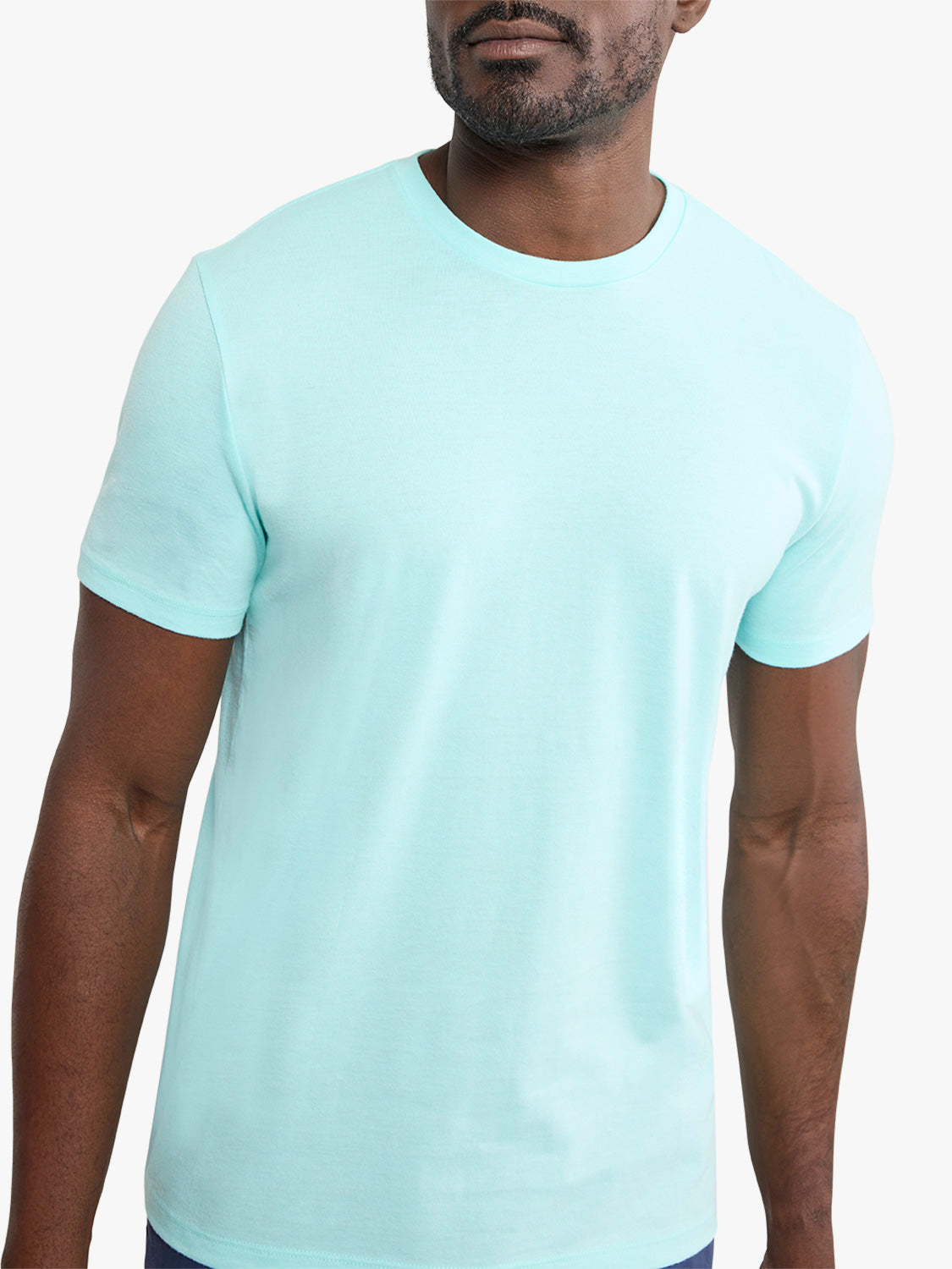Man wearing an aqua-colored short-sleeve crew neck t-shirt with a solid front design.