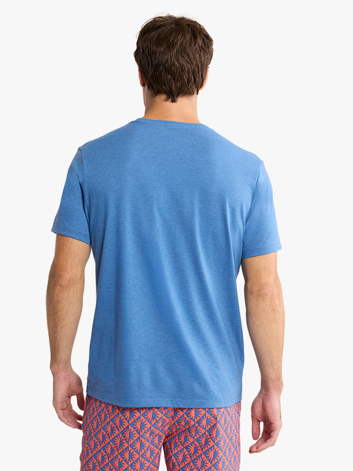 Man wearing a sea blue short-sleeved crew neck t-shirt, shown from behind.