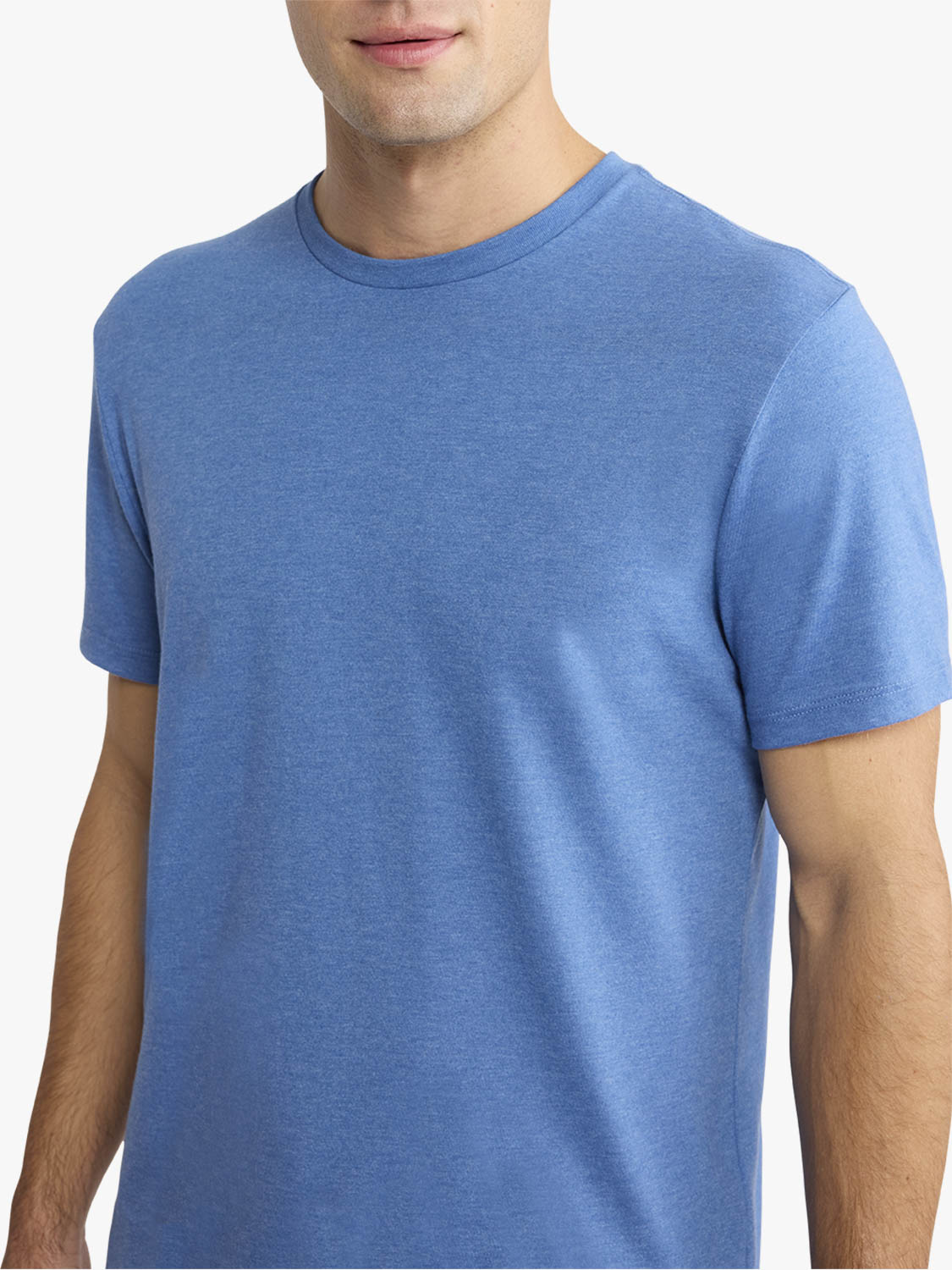 Man wearing a sea blue short-sleeve crewneck t-shirt against a white background.
