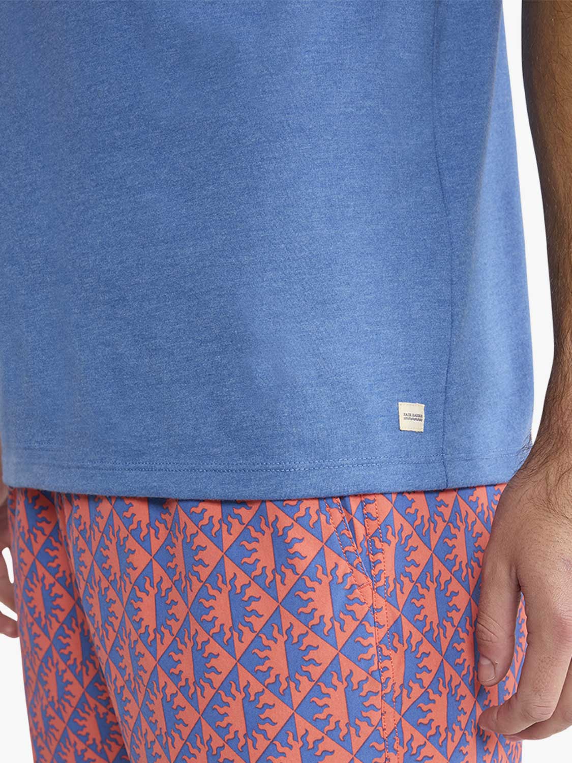 Sea blue short-sleeved t-shirt with a small woven label on the front.