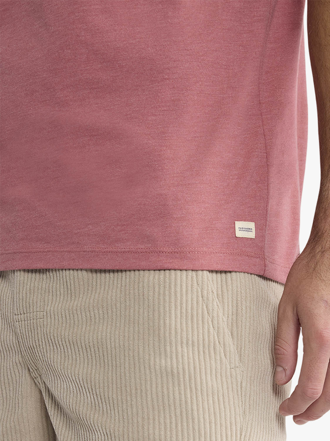 Mauve-pink graphic tee with small brand label visible on the lower front hem area.