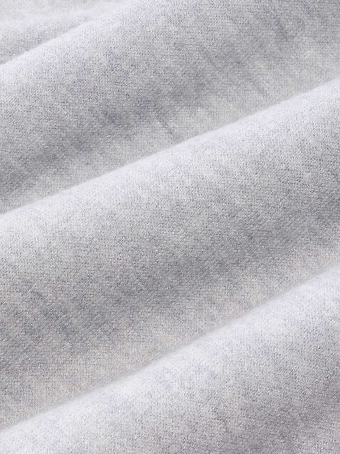 Heather grey blanket hoodie fabric displays soft texture with draped folds throughout.