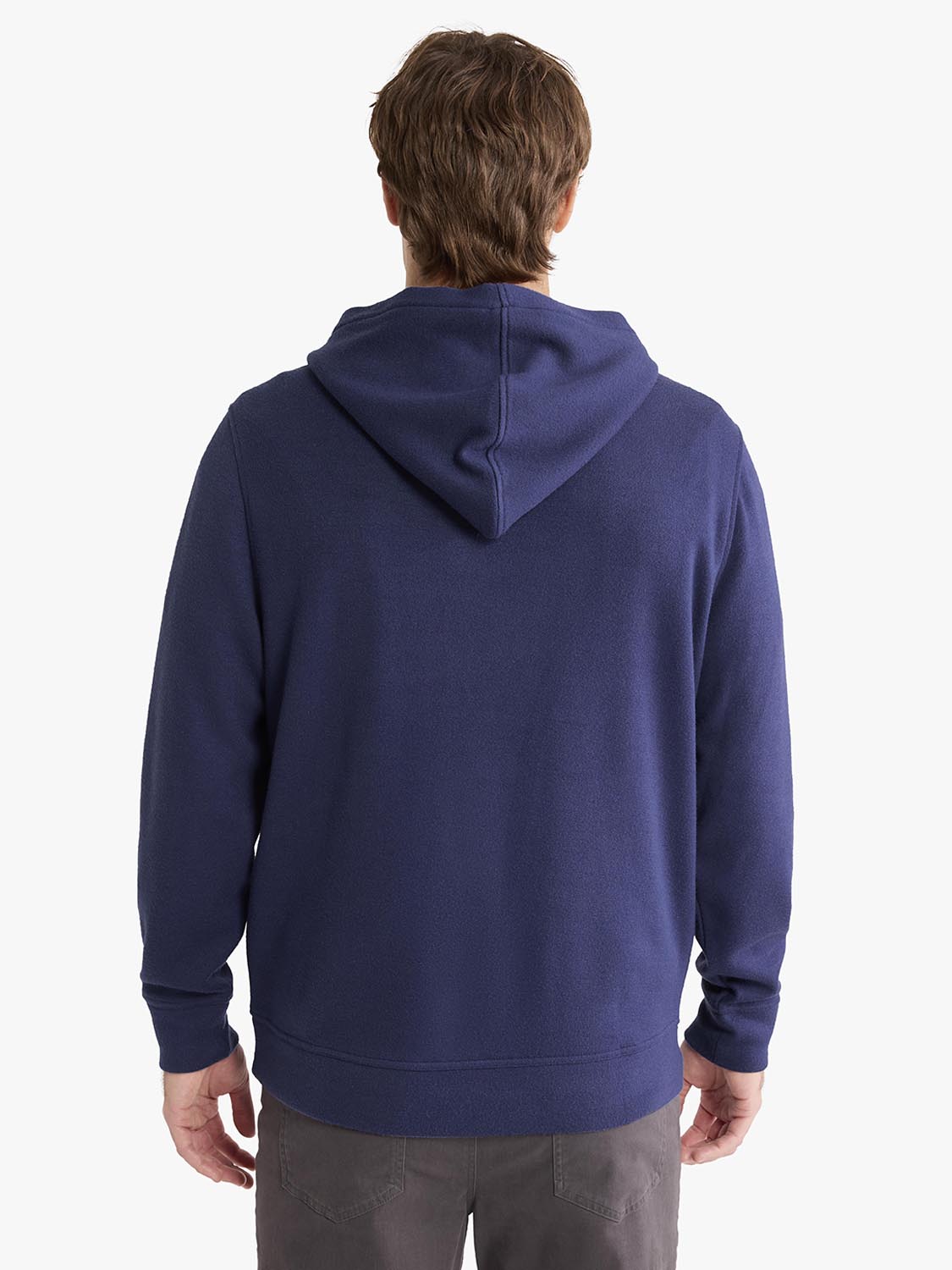 Person wearing a navy blue blanket hoodie with a hood, shown from the back view.