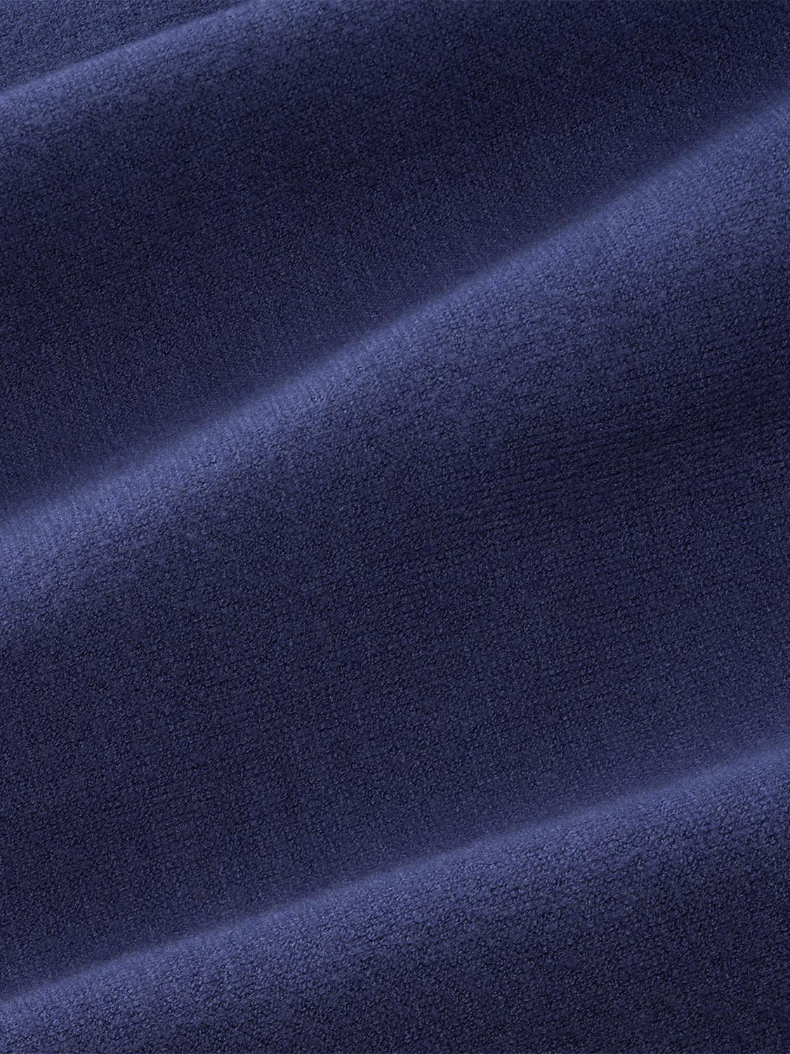 Close-up of navy blue textured fleece fabric with soft, plush surface and diagonal fold lines.