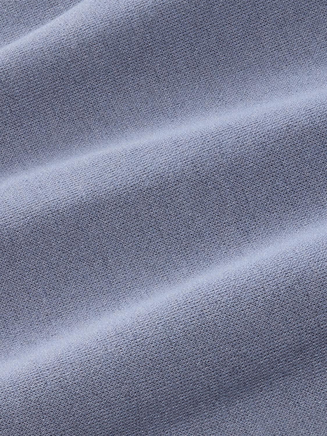 Blue-grey textured fabric with diagonal folds showing the woven surface detail of the blanket hoodie.