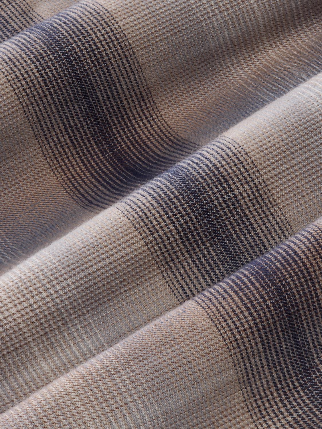 Sand ombre flannel shirt fabric displaying a plaid weave pattern in cream and navy blue tones.