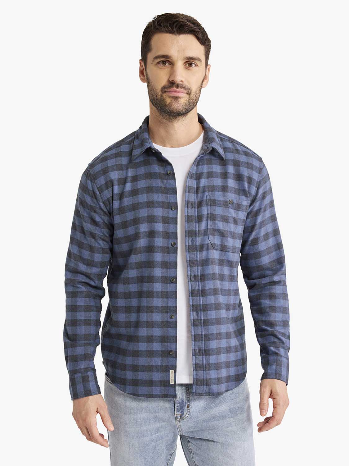 Man wearing a blue and charcoal check flannel shirt with long sleeves and front button closure.