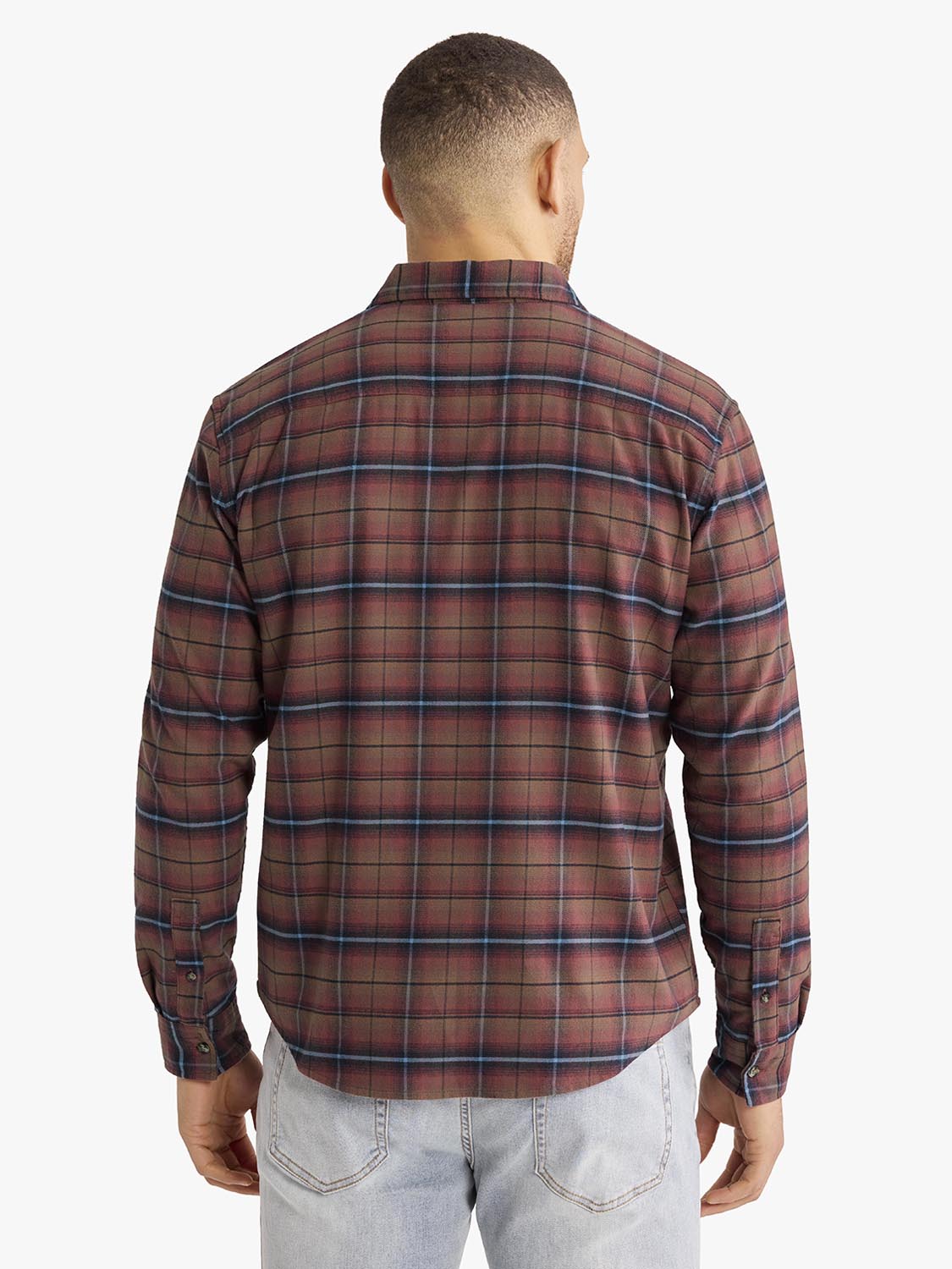 Man wearing burgundy and navy plaid flannel shirt with long sleeves, shown from behind.