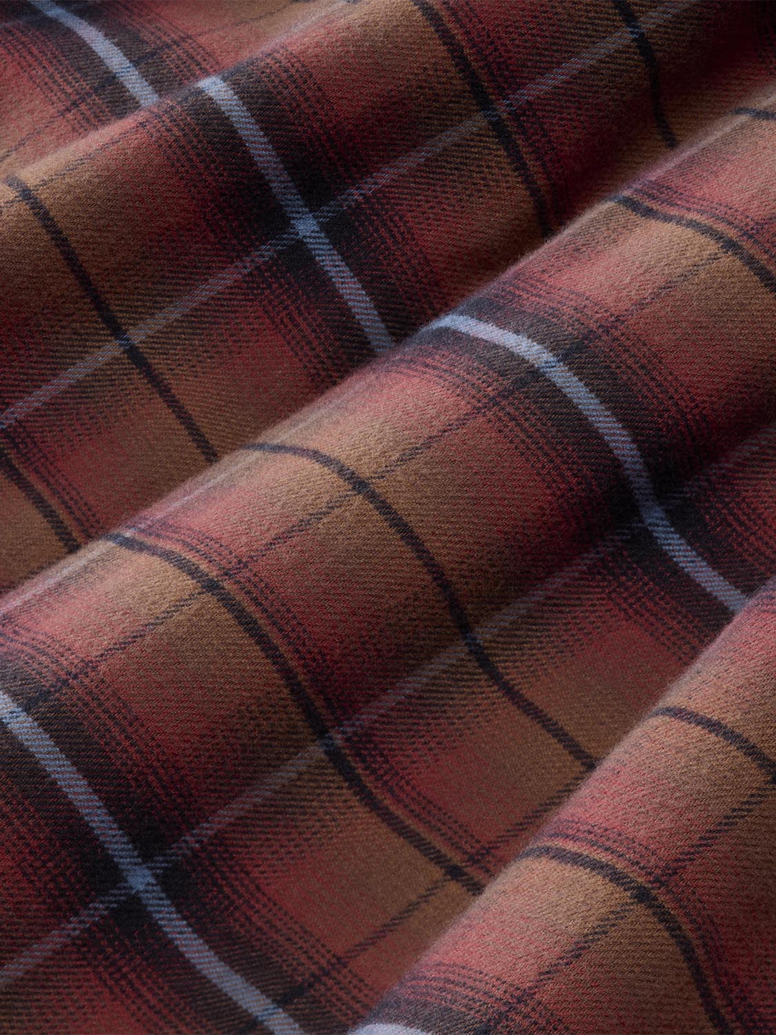 Burgundy plaid flannel fabric with intersecting lines in black and blue tones.