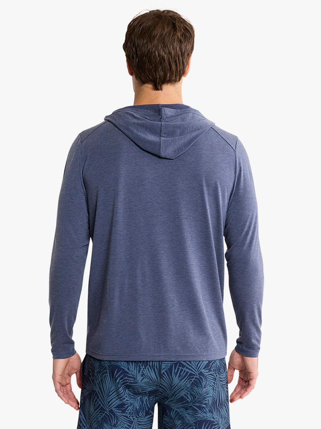 Man wearing a navy blue hoodie with long sleeves, shown from the back view.