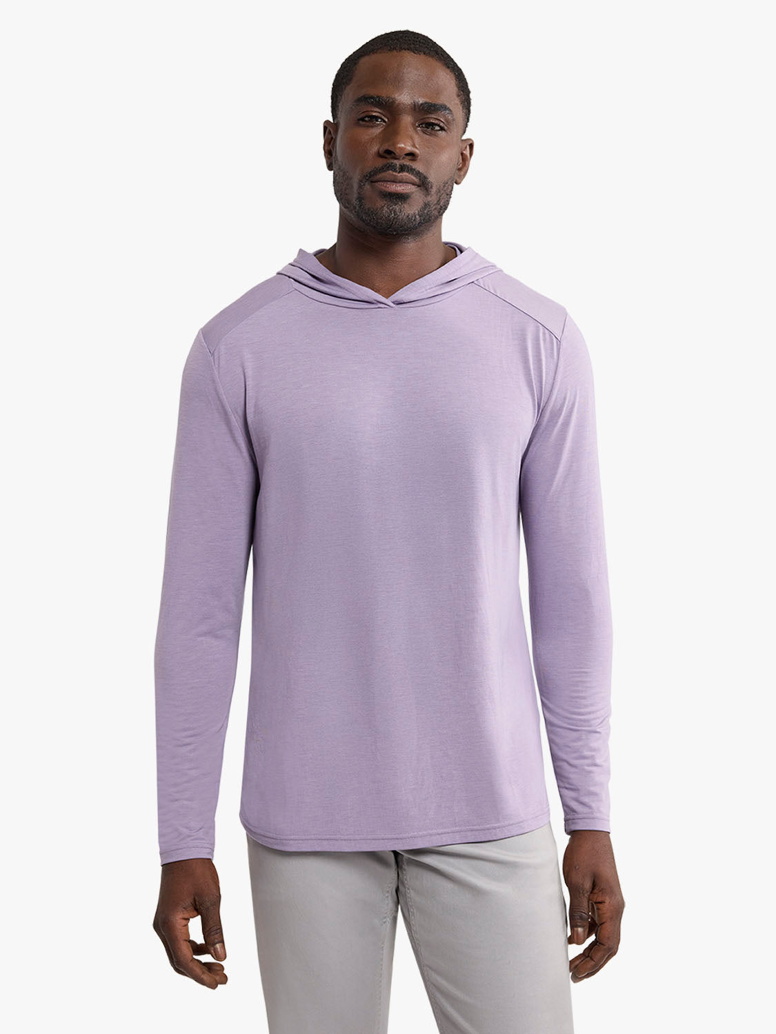 Man wearing a light purple long-sleeve hoodie with a relaxed fit and neutral gray pants.