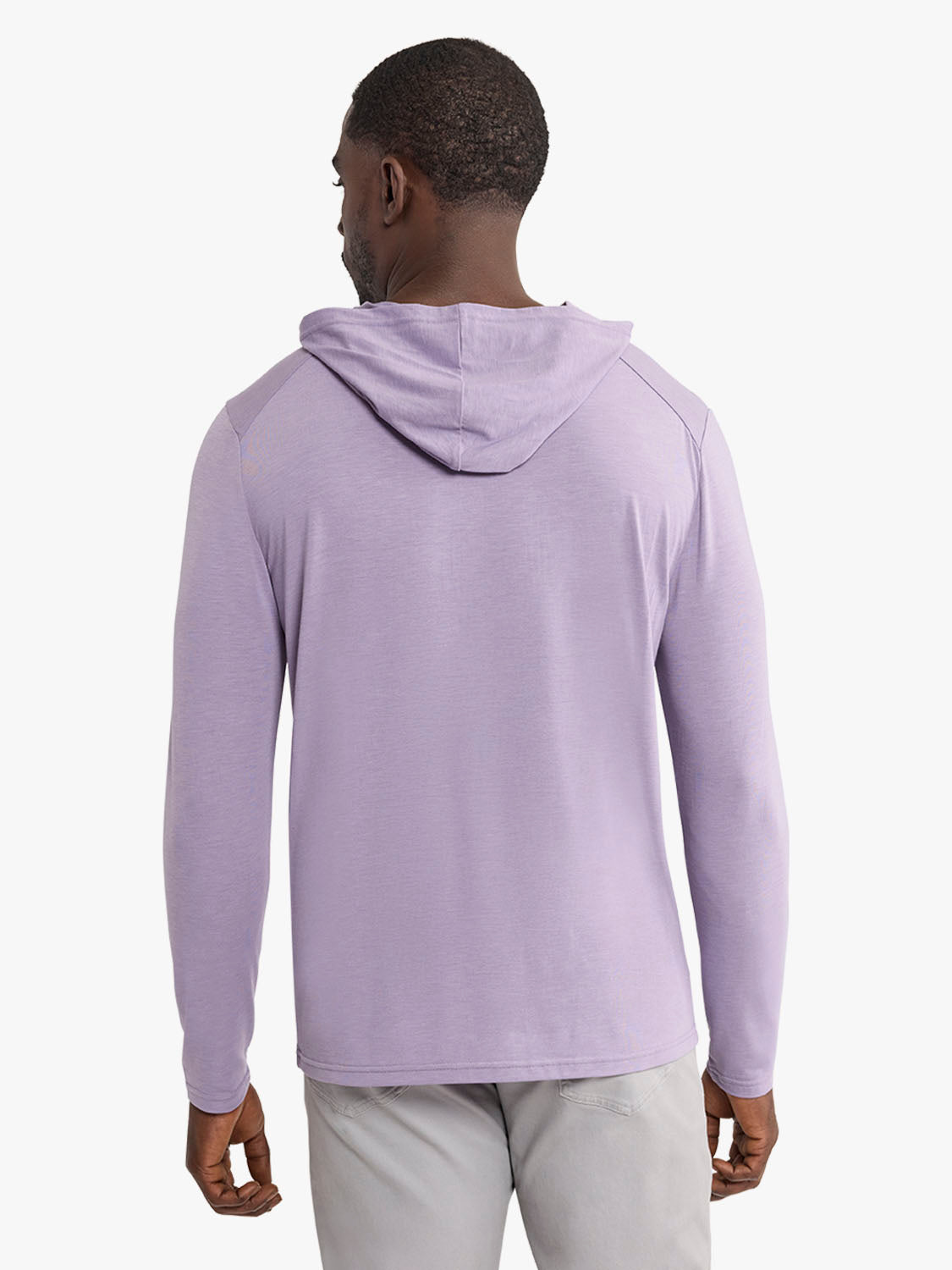 Man wearing a light purple hoodie with long sleeves and a drawstring hood, shown from behind.