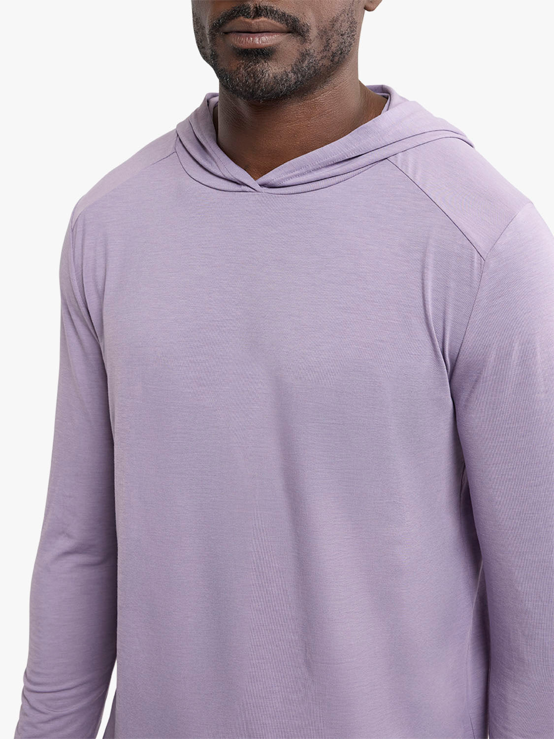 Man wearing a light purple long-sleeve hoodie with a drawstring hood and textured fabric.