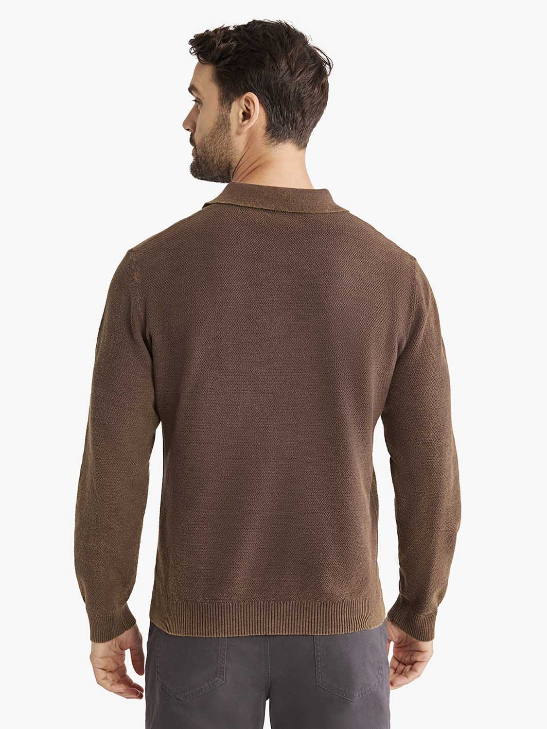 Man wearing an espresso brown long sleeve polo shirt with a textured knit fabric and collar.