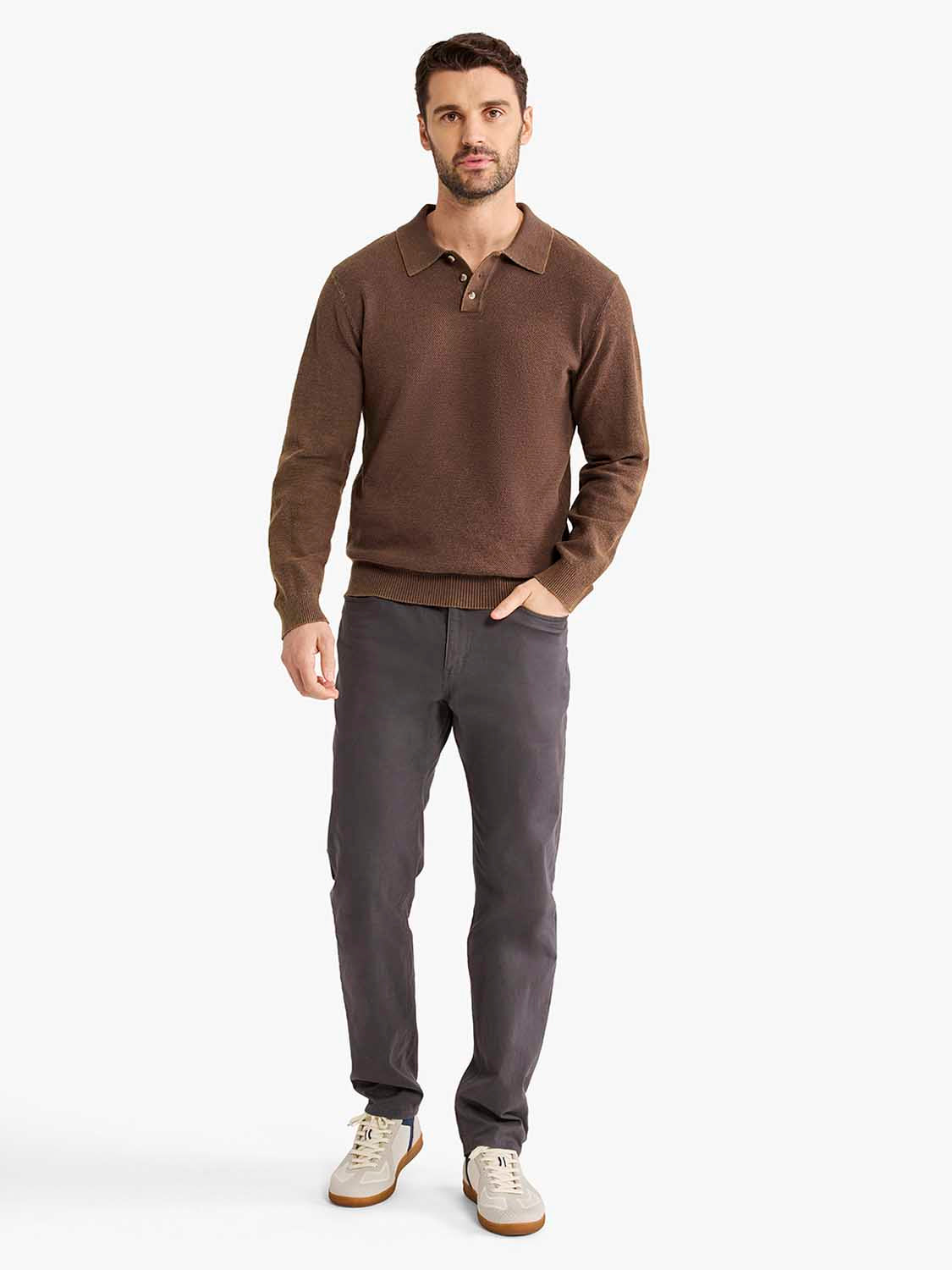 Man wearing espresso brown long sleeve polo shirt with collar and buttons, paired with charcoal pants.