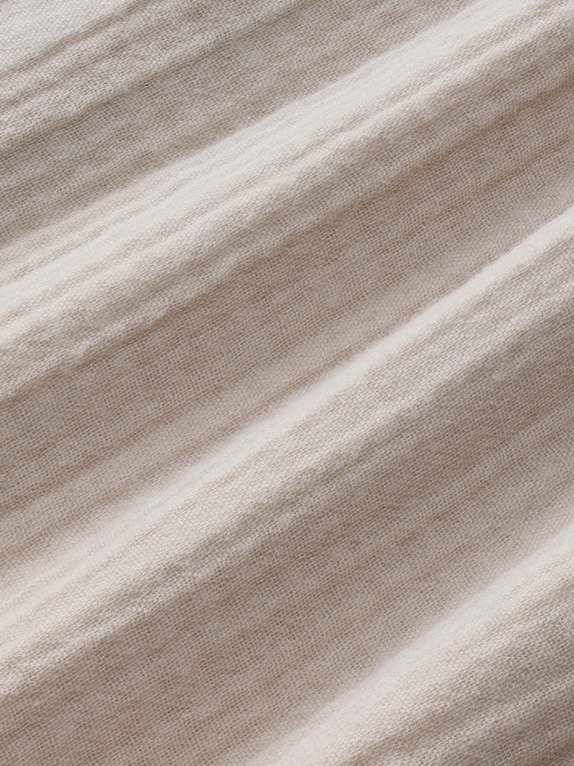 Beige and cream striped fabric with a textured, woven surface and diagonal folds throughout.