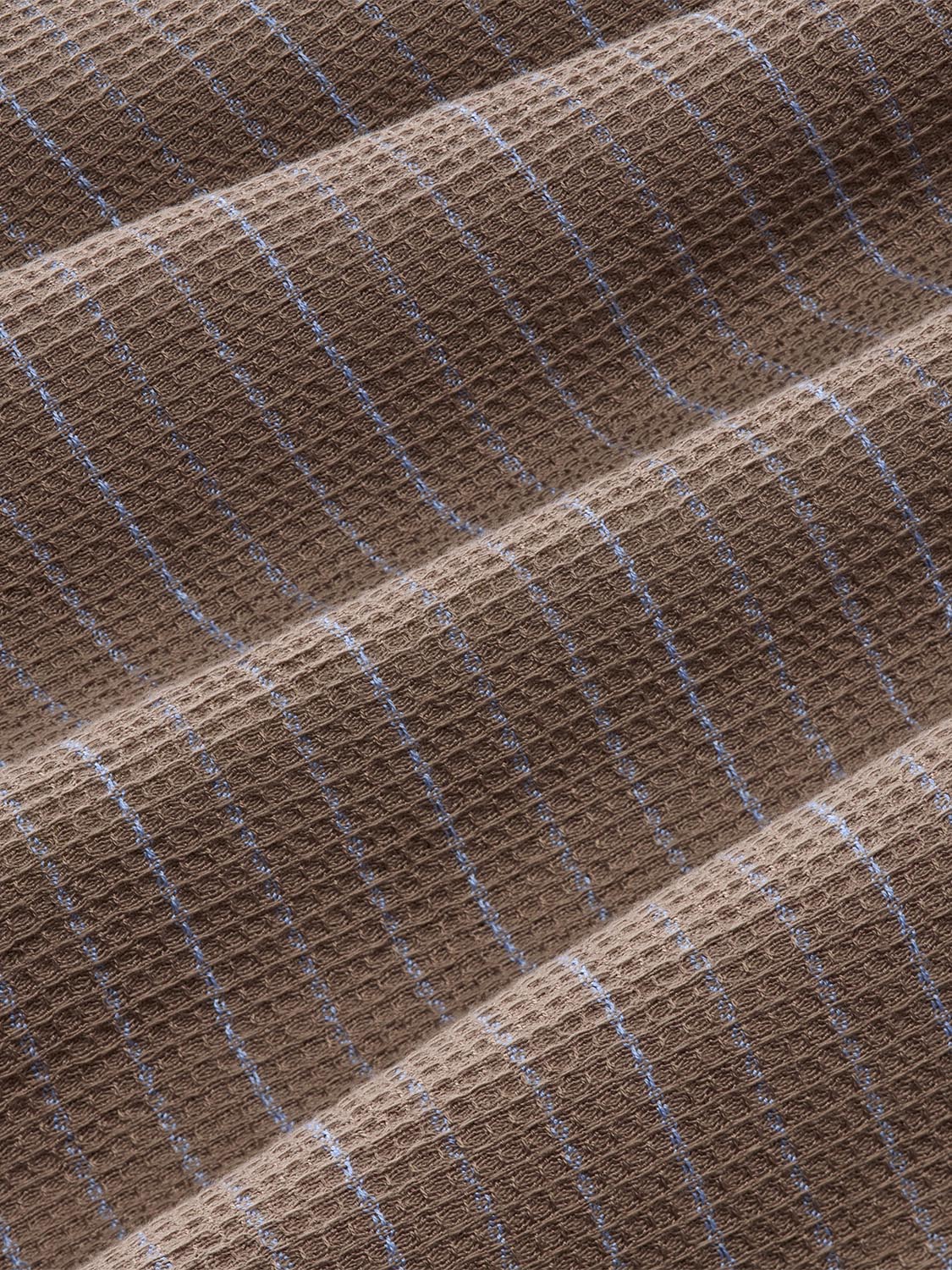 Tan and blue striped waffle textured fabric with vertical stripes and diagonal weave pattern.