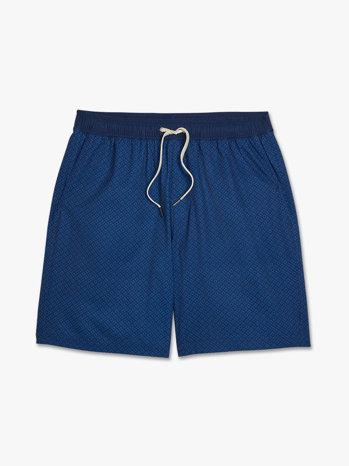 Blue shorts with an all-over circle pattern and drawstring waistband displayed on a neutral background.