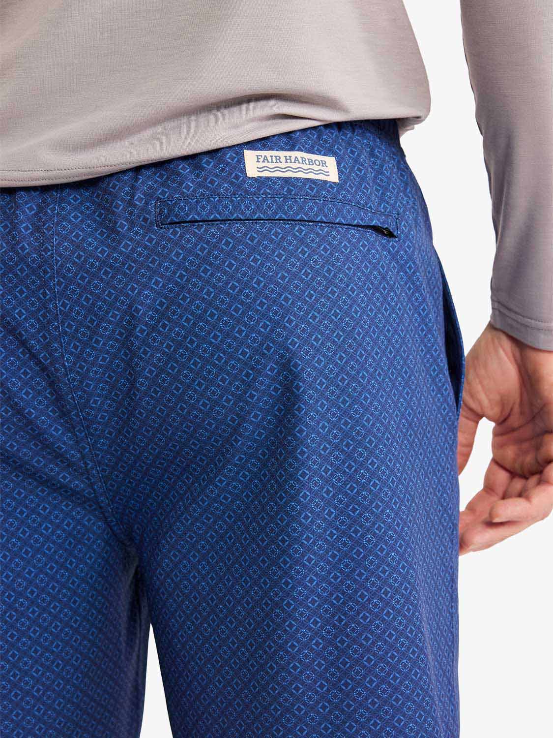 Blue shorts with an all-over geometric circle pattern and Fair Harbor brand label visible.