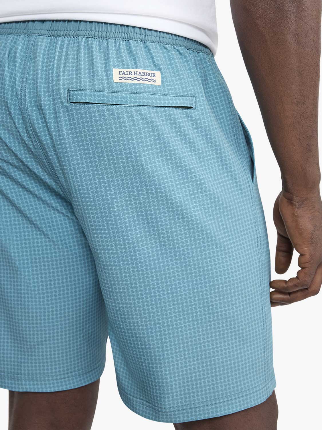 Turquoise shorts with geometric pattern featuring Fair Harbor label and back pocket on model.