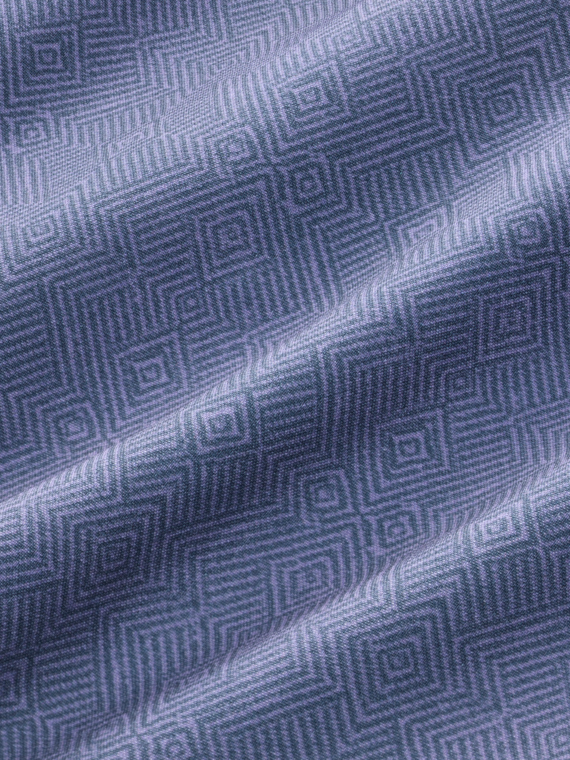 Purple and blue fabric with a geometric diamond pattern woven throughout the textile surface.