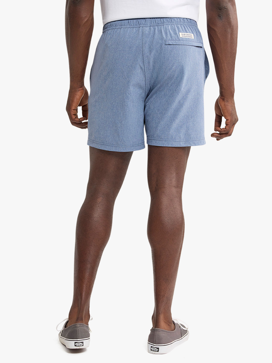 Man wearing light blue shorts with an elastic waistband and back pocket, paired with white tank top.