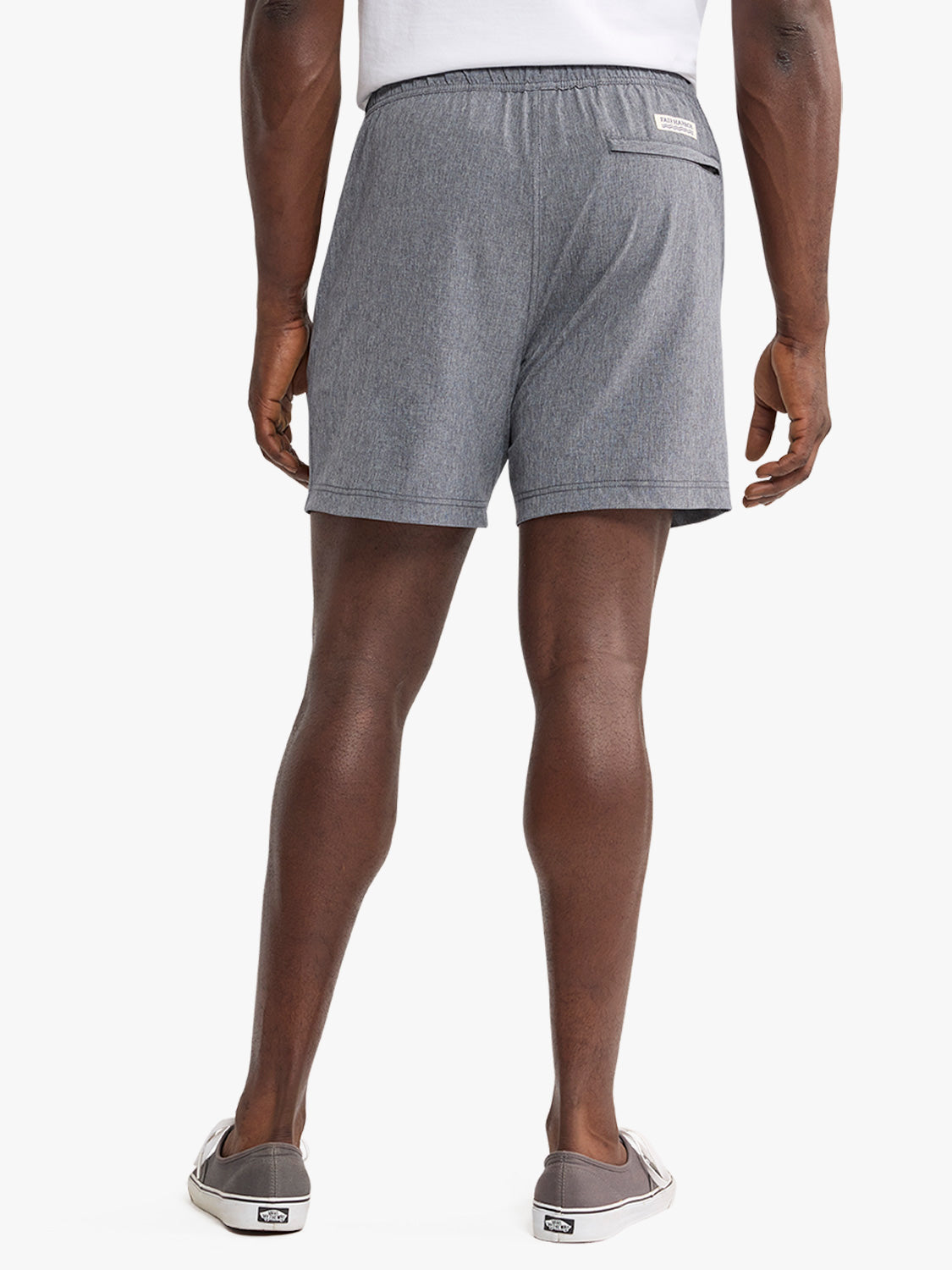 Man wearing grey shorts with an elastic waistband viewed from behind.