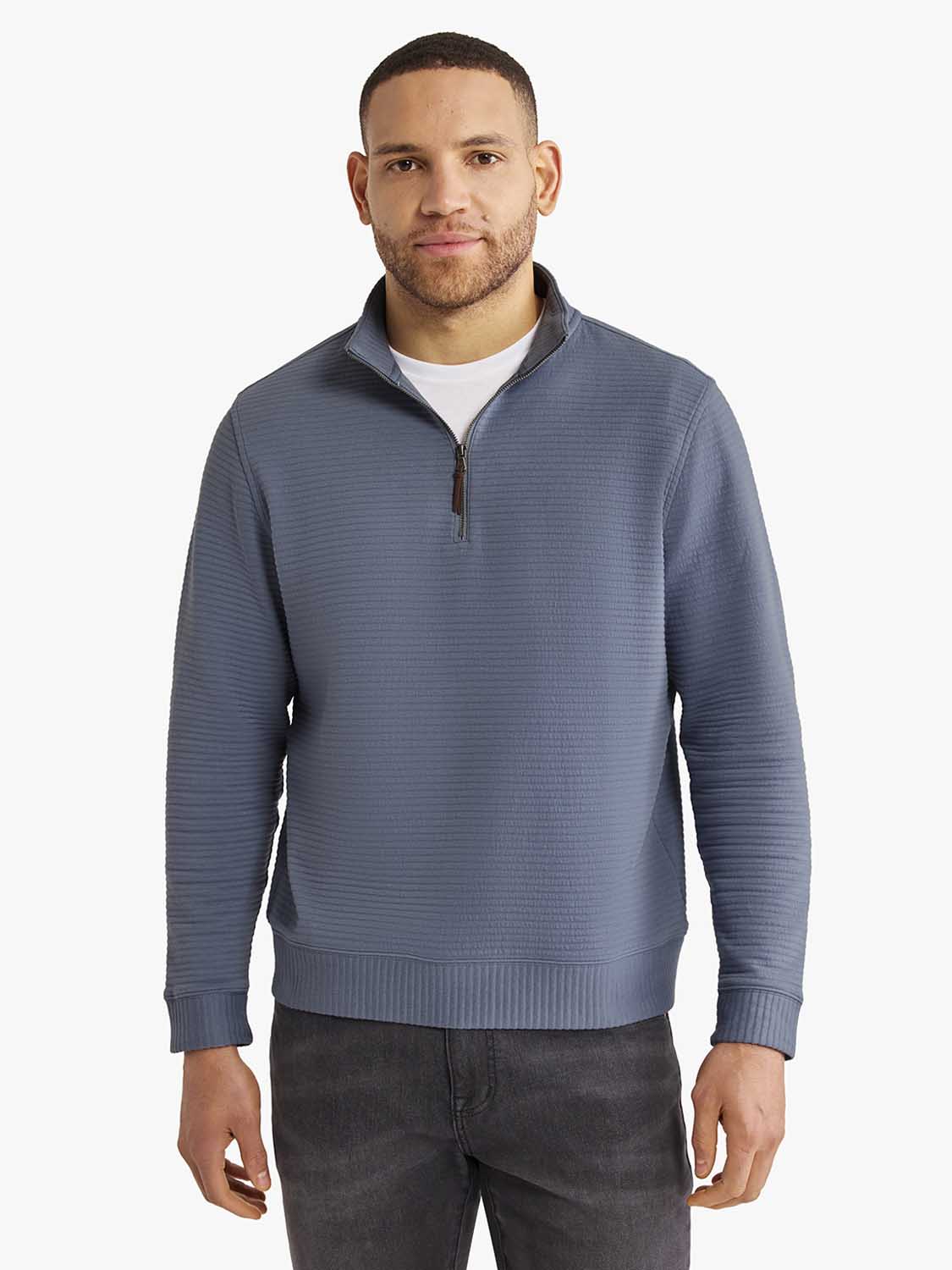 Man wearing a maritime blue quarter zip pullover with textured knit fabric over a white shirt.