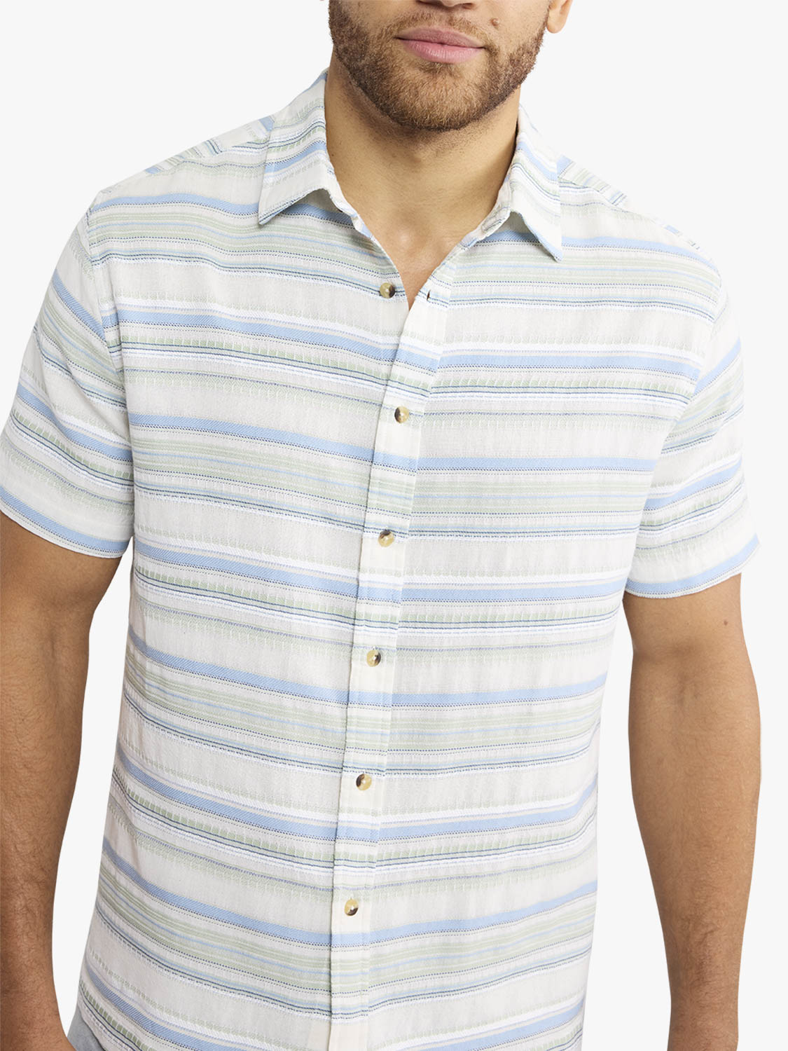 Man wearing short-sleeve button-up shirt with horizontal blue and green stripes on white background.