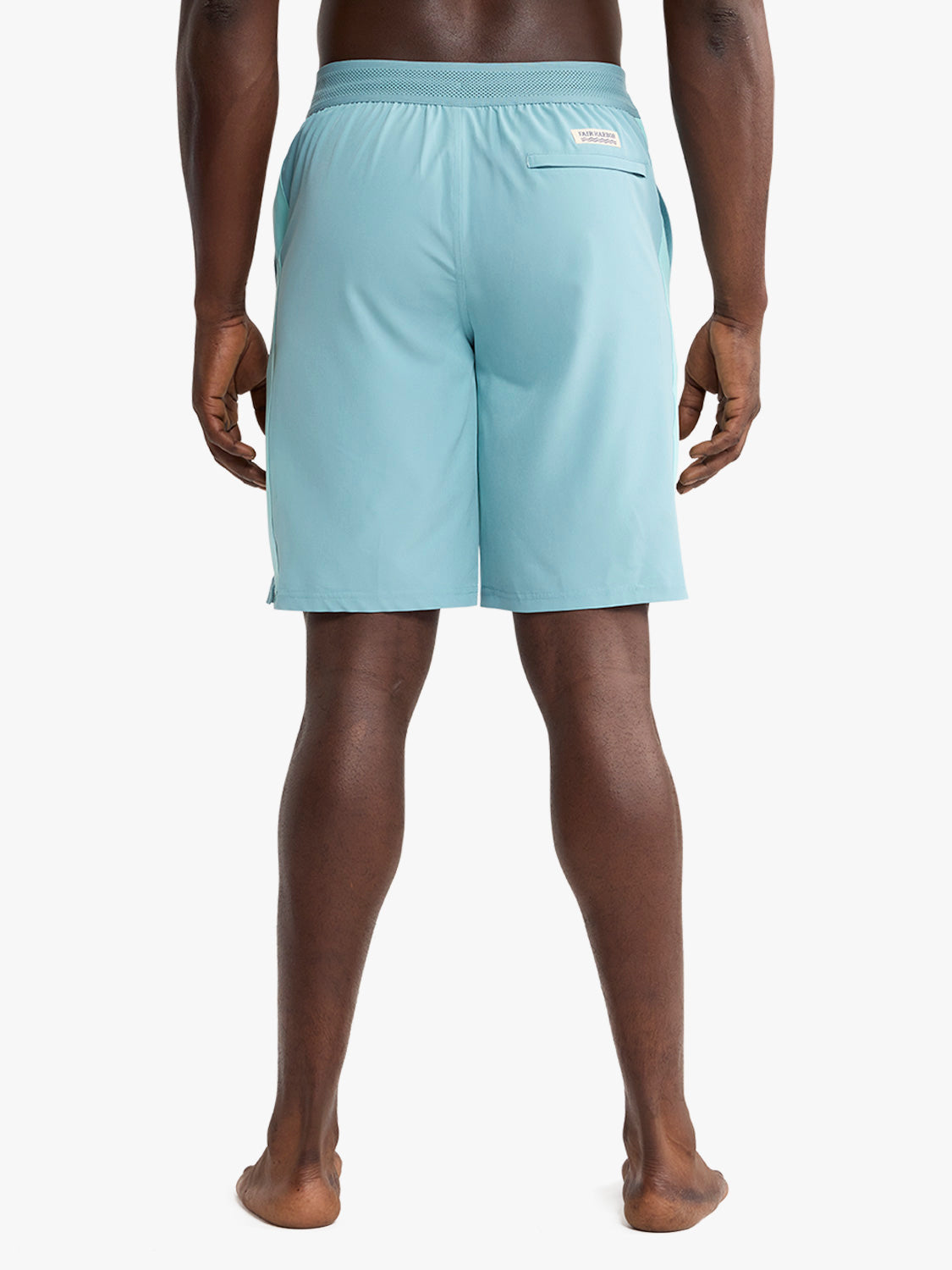 Man wearing light blue shorts with elastic waistband and back pocket viewed from behind.