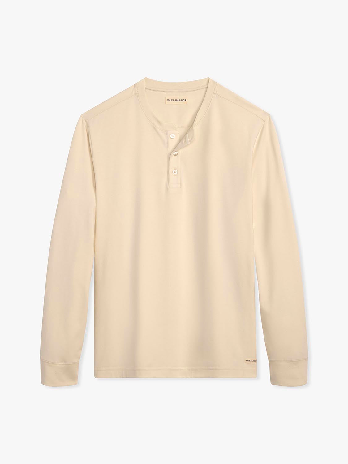Cream-colored long-sleeve henley shirt with buttoned placket and ribbed cuffs displayed against white background.