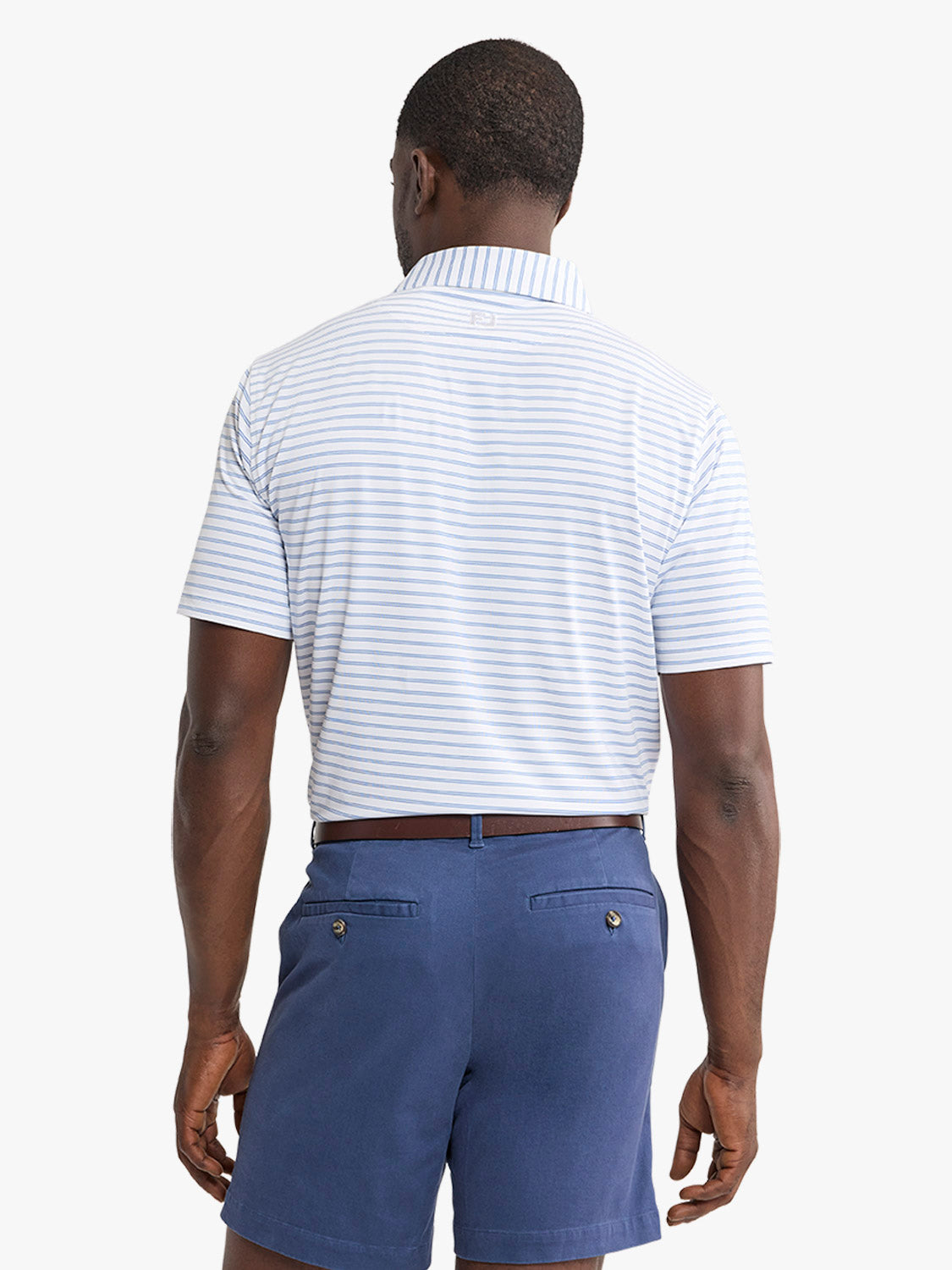 Man wearing a light blue and white striped polo shirt with a collar and navy shorts.