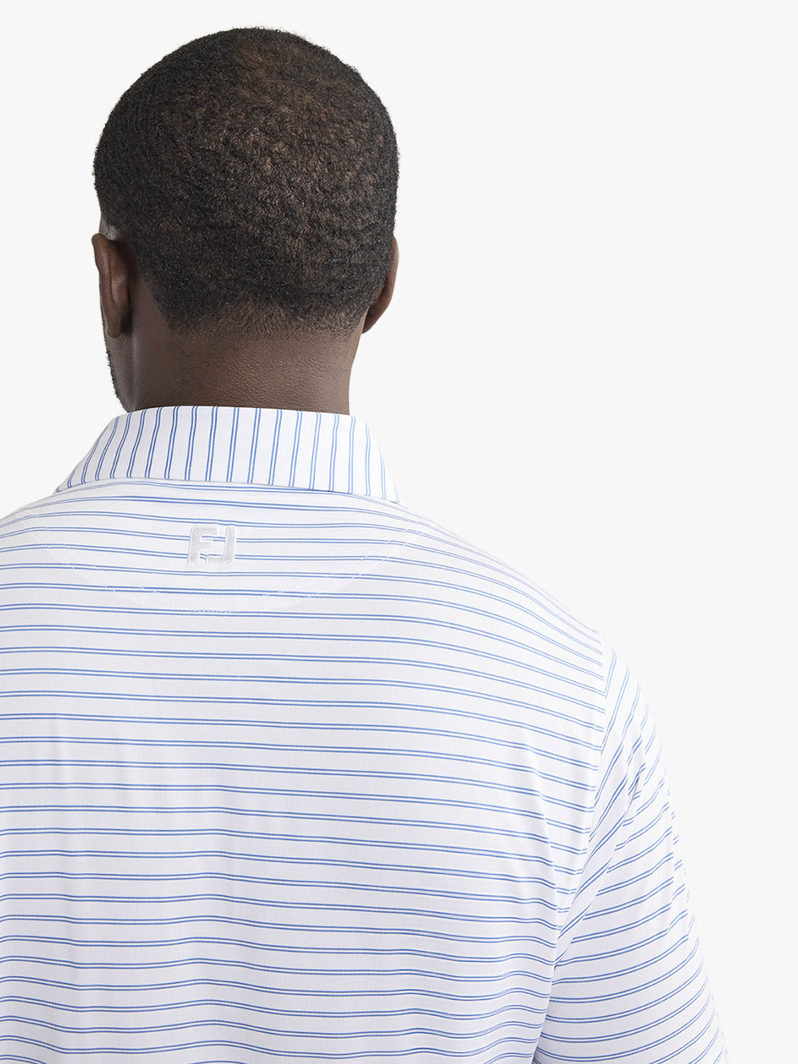 Man wearing a white polo shirt with blue vertical stripes viewed from the back.