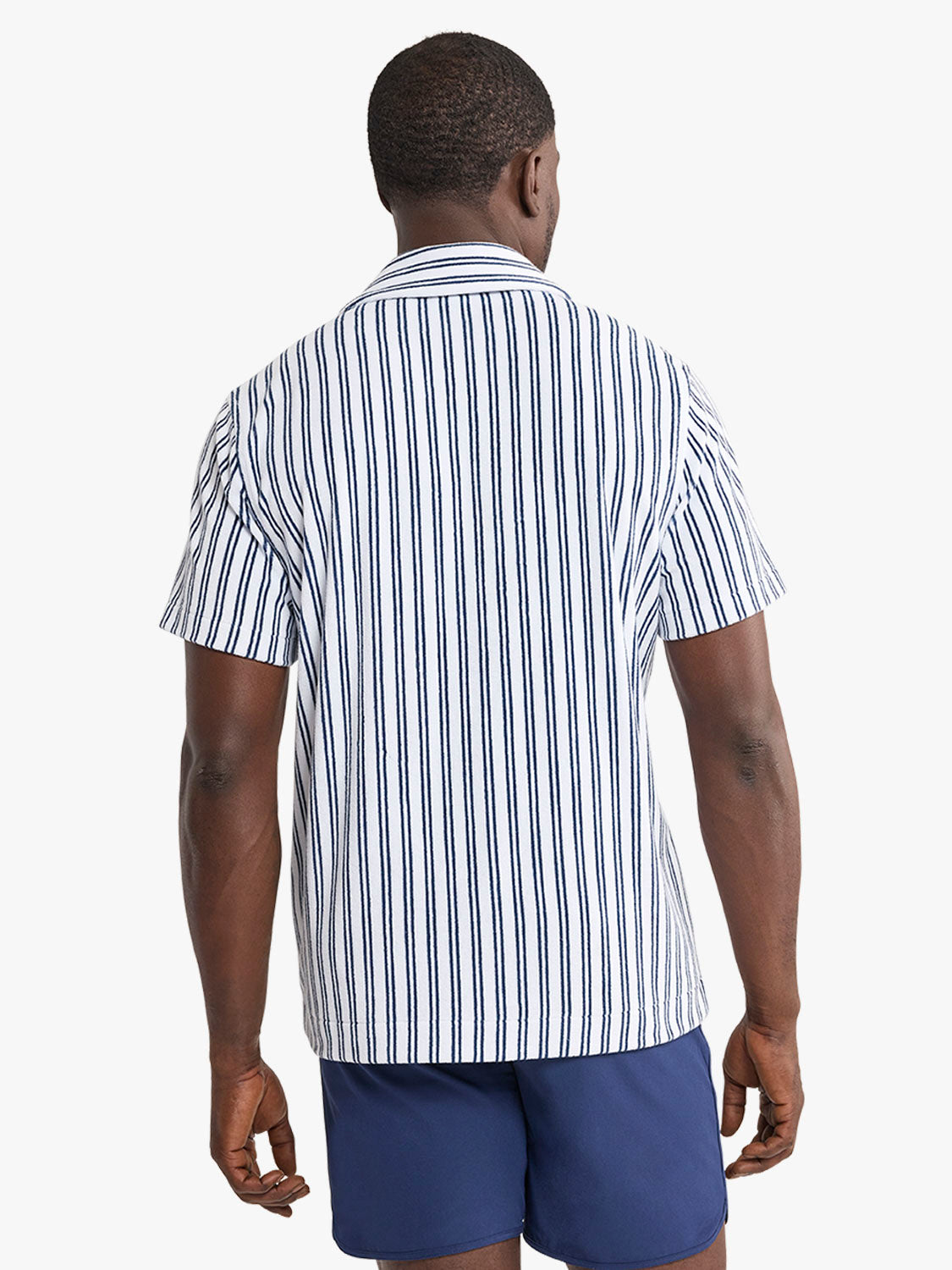 Man wearing short sleeve button up shirt with blue and white vertical stripes.